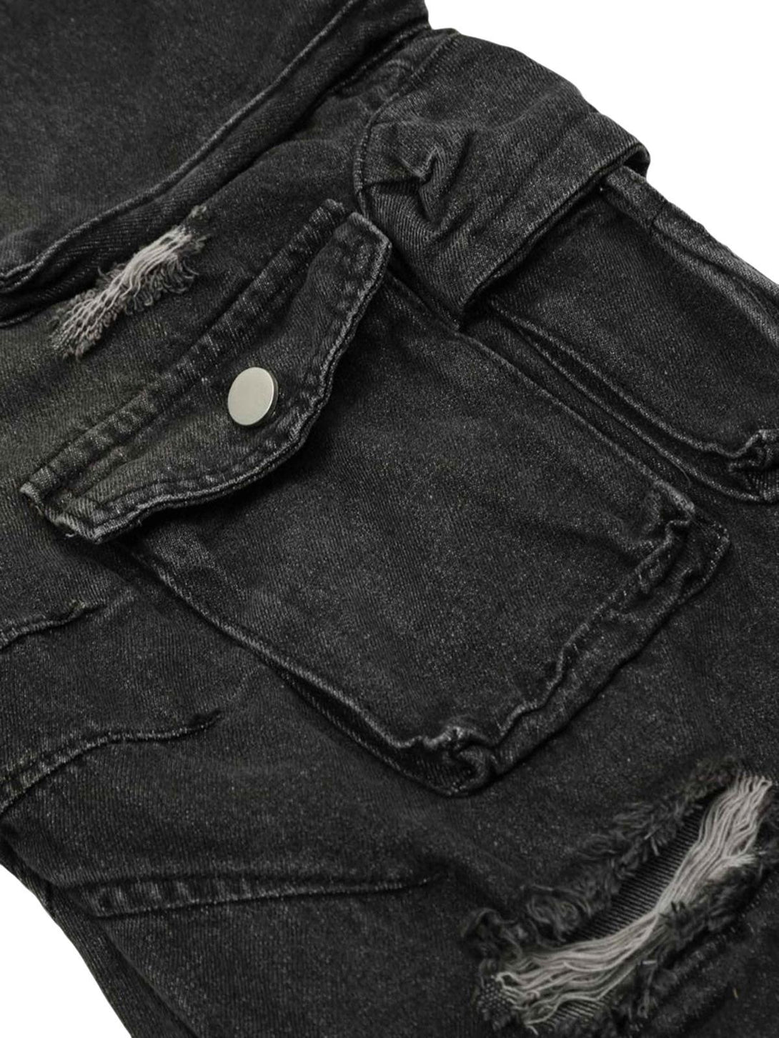Detailed view of TALISHKO's distressed cargo jeans, highlighting rugged pockets and texture.