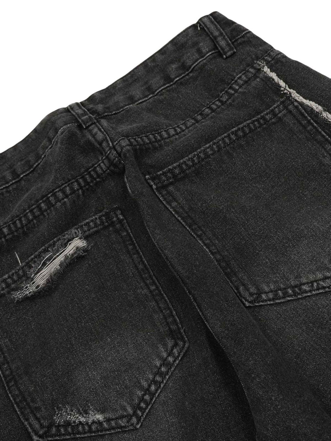 Detailed view of TALISHKO's washed cargo jeans, showcasing distressed pockets and texture.
