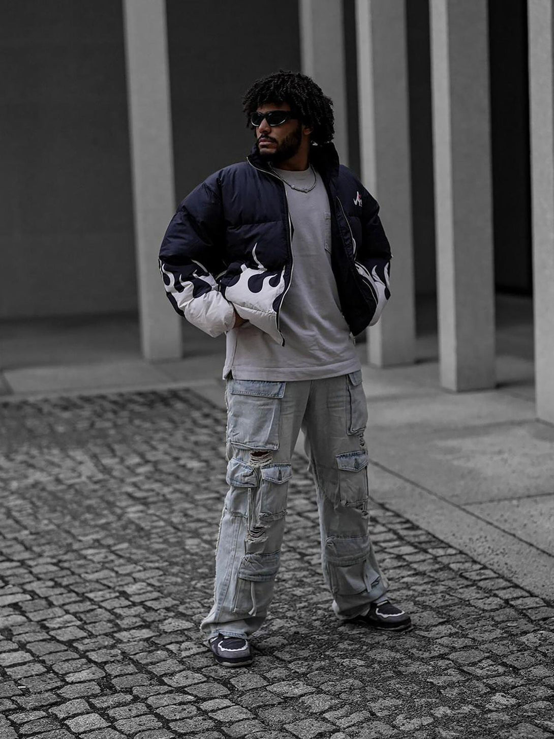 Model wearing TALISHKO washed cargo jeans with a flame-design jacket and sneakers.