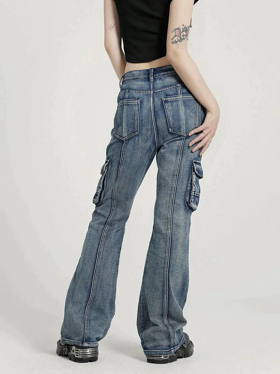 Model in TALISHKO washed jeans, showcasing cargo pocket detail and relaxed fit.