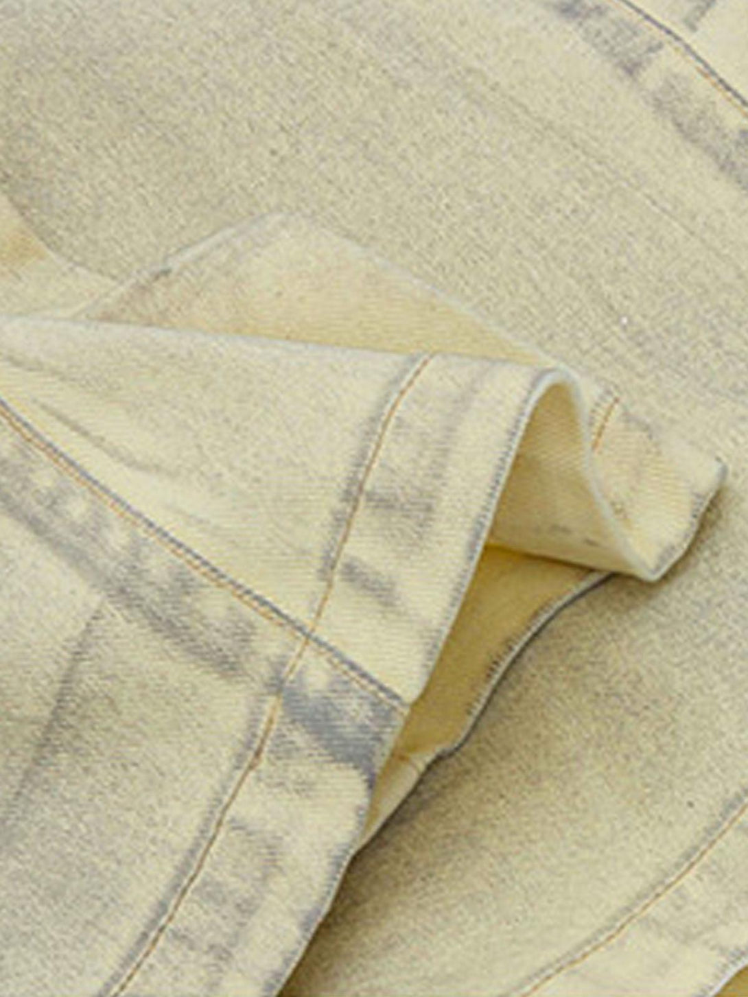 Zoomed-in texture of TALISHKO baggy denim shorts, featuring unique washed print details.