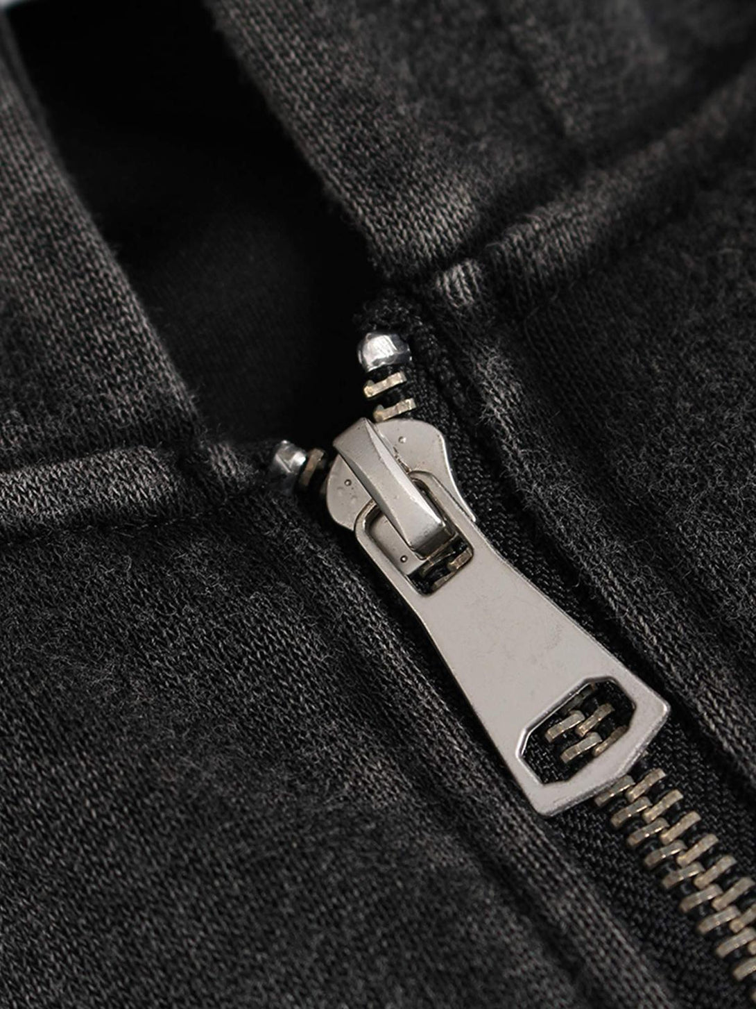 A close-up of TALISHKO's washed racing hoodie zipper, highlighting fabric texture and detail.