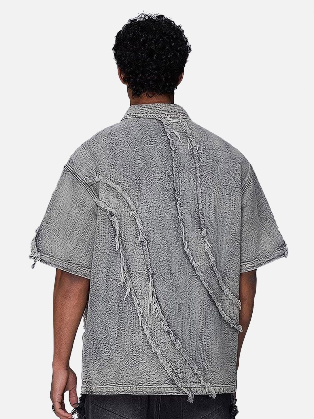 Back view of a TALISHKO denim shirt with textured raw edges, showcasing a rugged style.