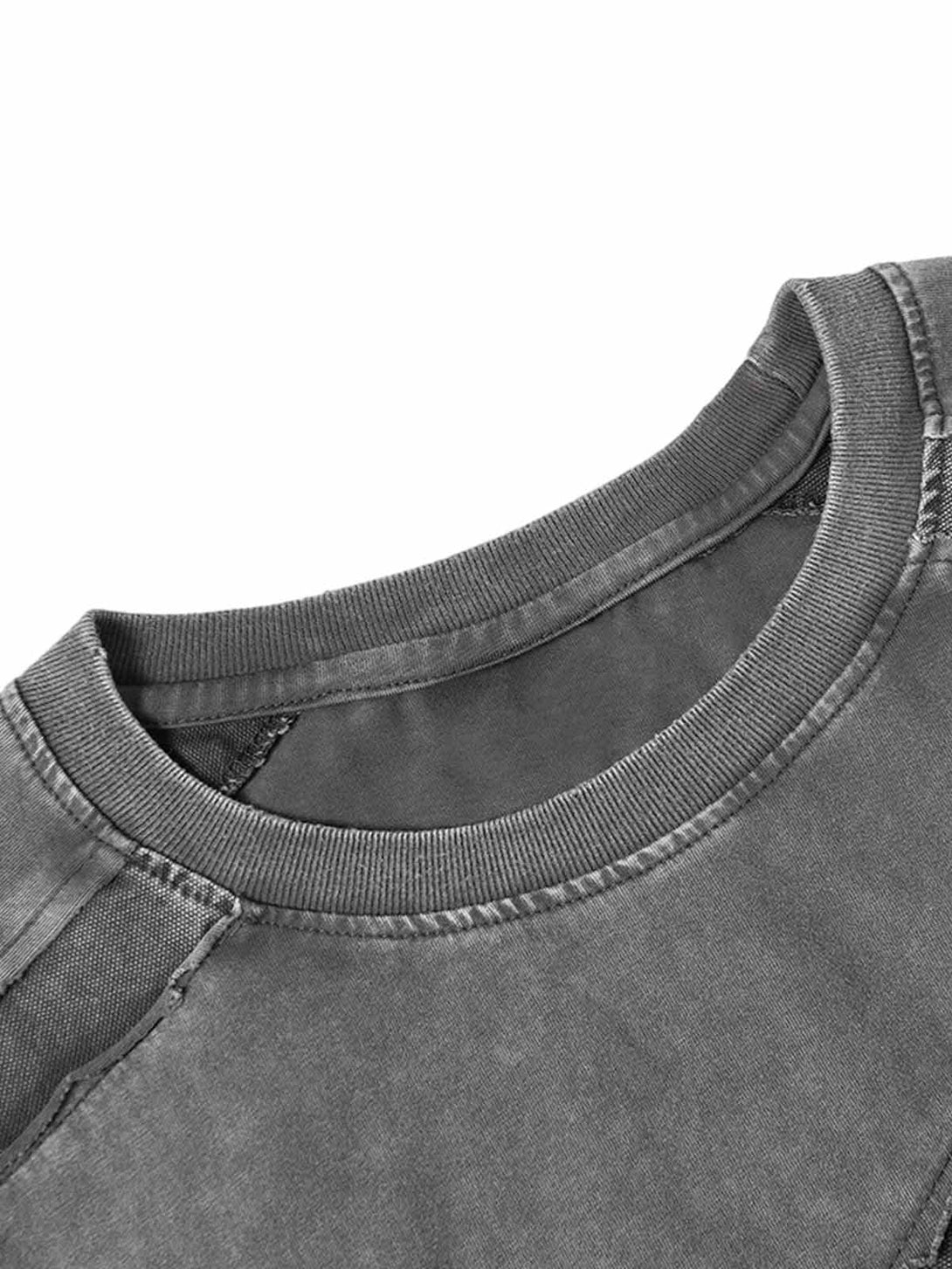 A detailed look at TALISHKO's washed oversized T-shirt, highlighting raw edges and texture.