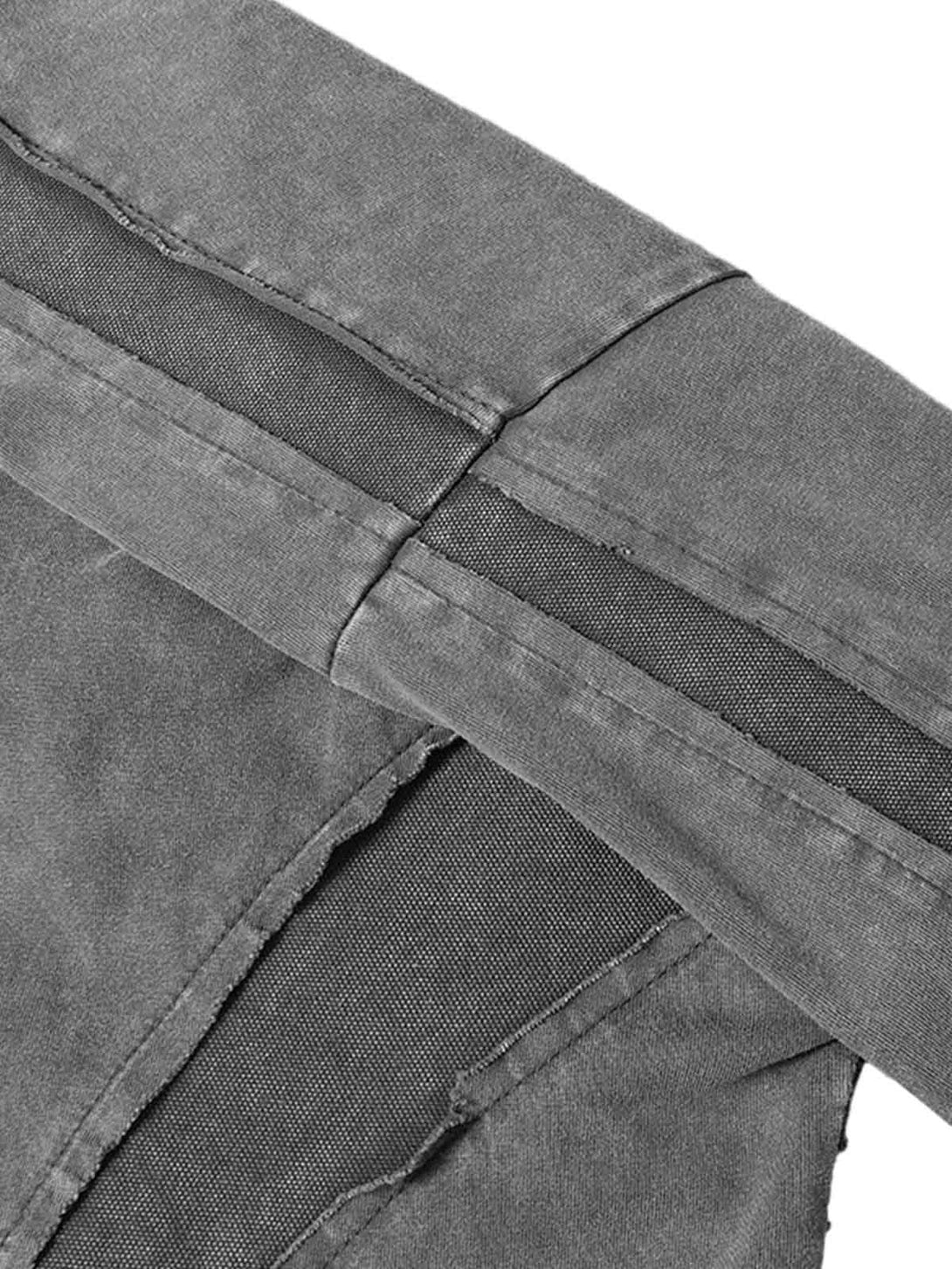 Detailed fabric and stitching on TALISHKO's oversized T-shirt, highlighting raw edges and texture.