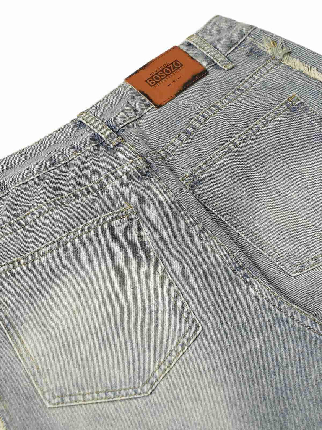 Back detail of washed baggy jeans by TALISHKO, showcasing pockets and faded texture.