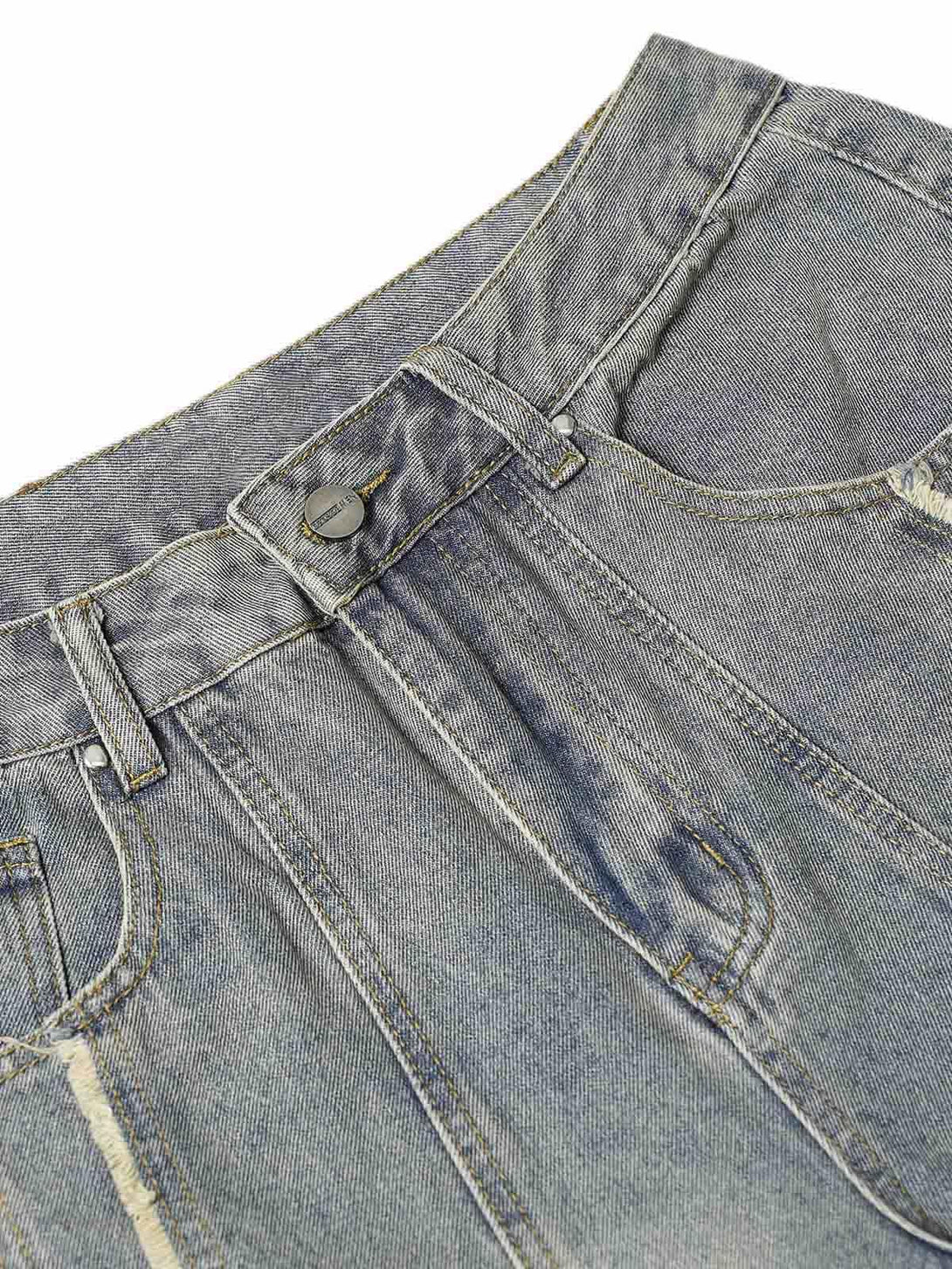 Detailed view of TALISHKO baggy jeans, highlighting the washed texture and relaxed fit.