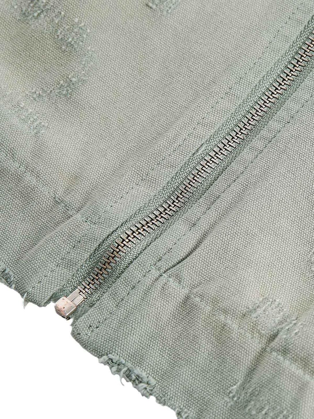 Intricate look at TALISHKO's washed ripped zip-up jacket fabric, highlighting its rugged texture.