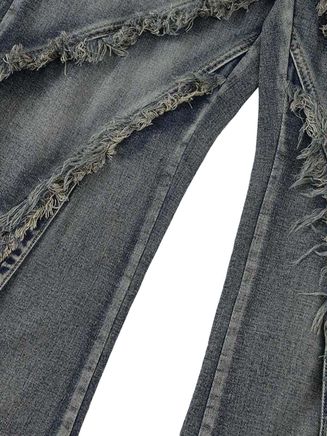 Intricate look at TALISHKO's baggy jeans, highlighting raw edge details and washed texture.