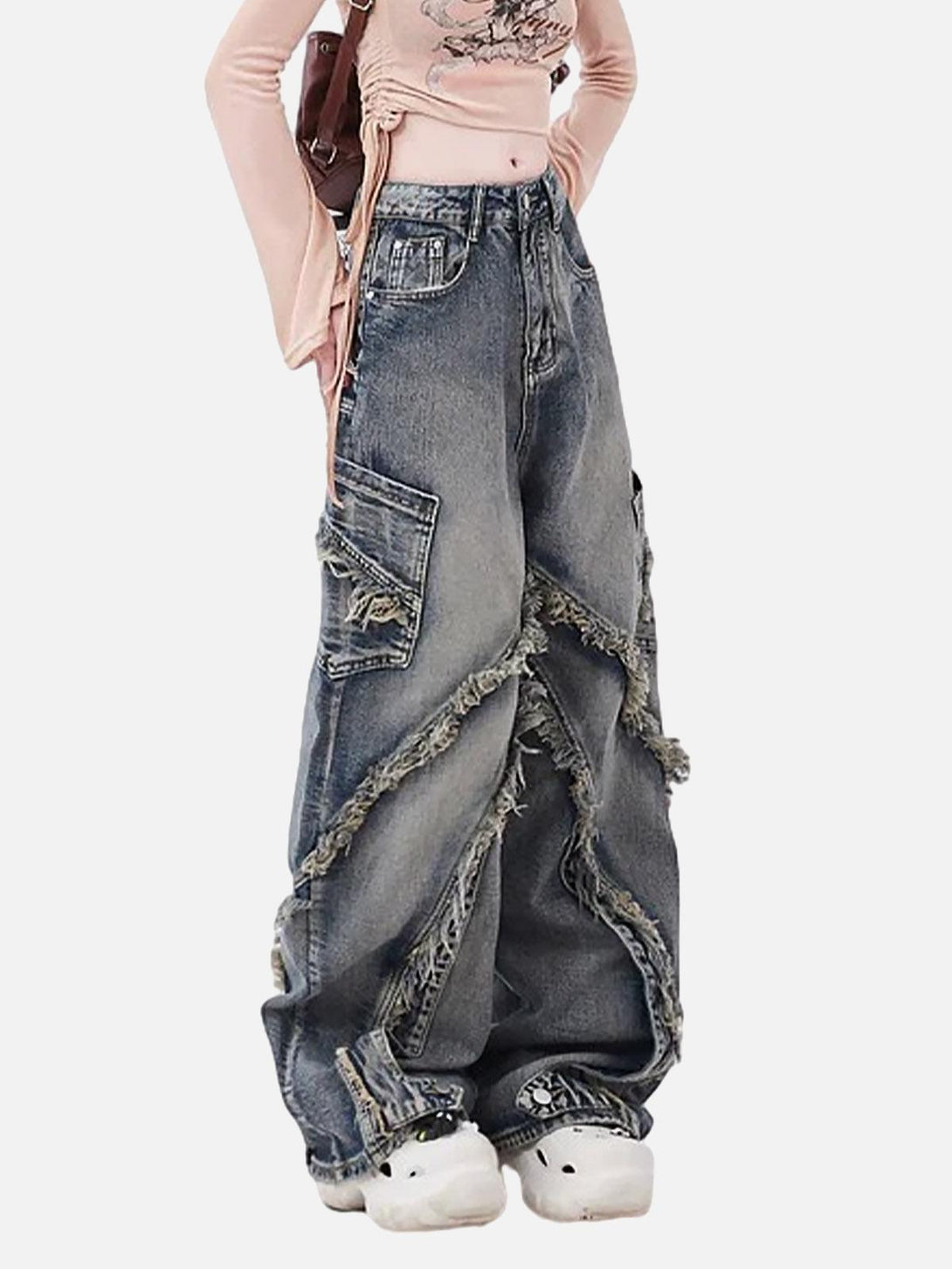 Model styled in TALISHKO washed baggy jeans with raw edges and roomy side pockets.