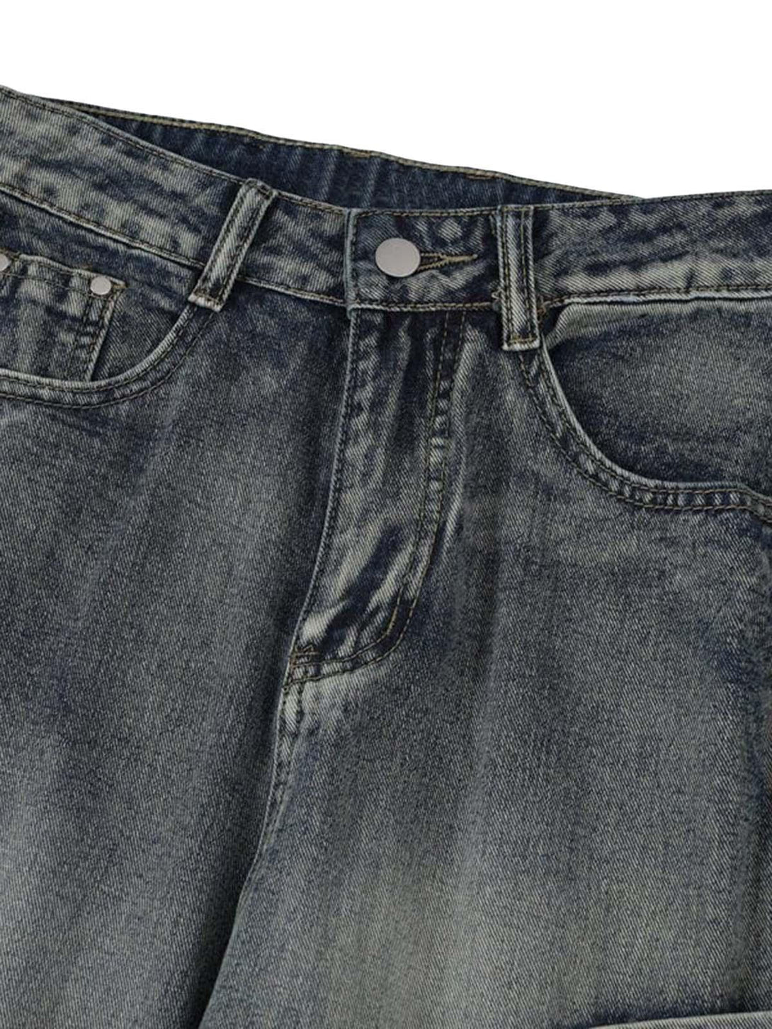 Detailed fabric and stitching of TALISHKO washed baggy jeans, highlighting raw edges.