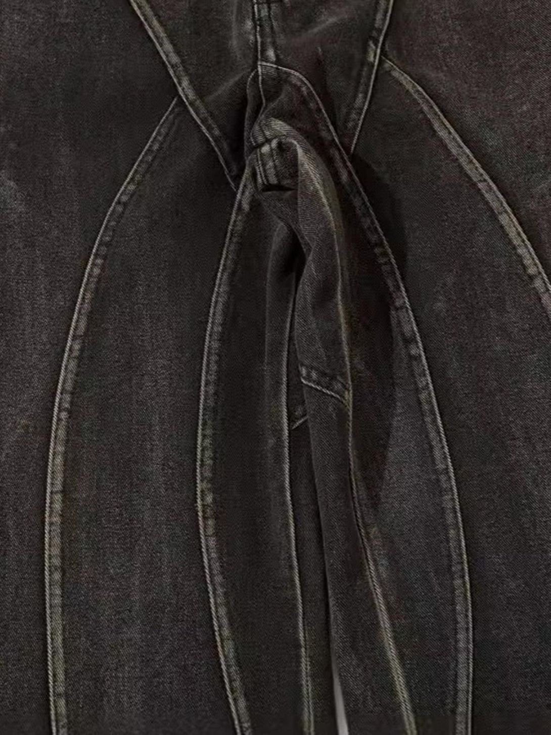 Intricate look at TALISHKO's washed hip-hop horn jeans, showcasing unique seam detailing.