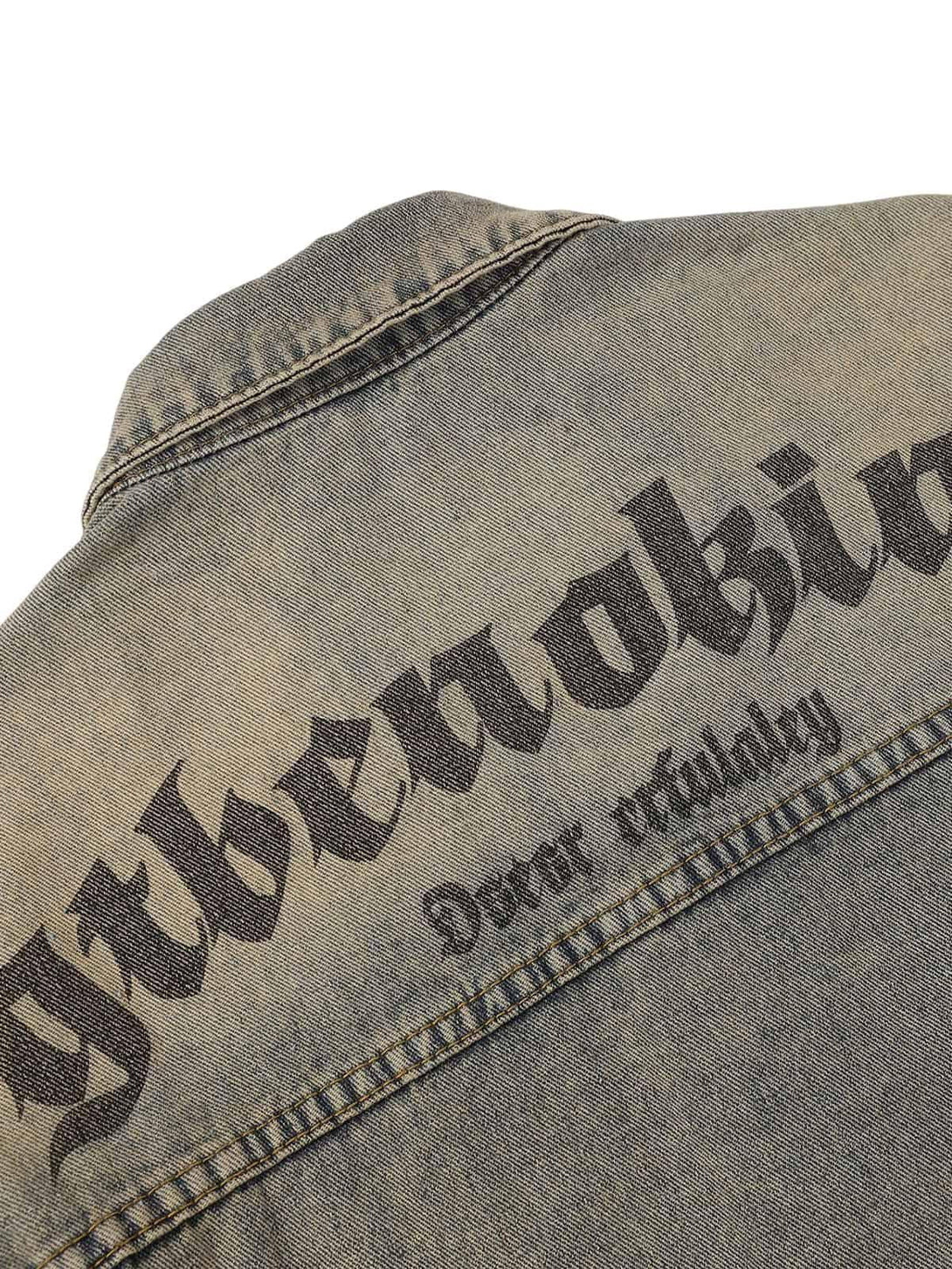 Zoomed-in texture of TALISHKO's denim jacket, highlighting vintage letter print on the back.