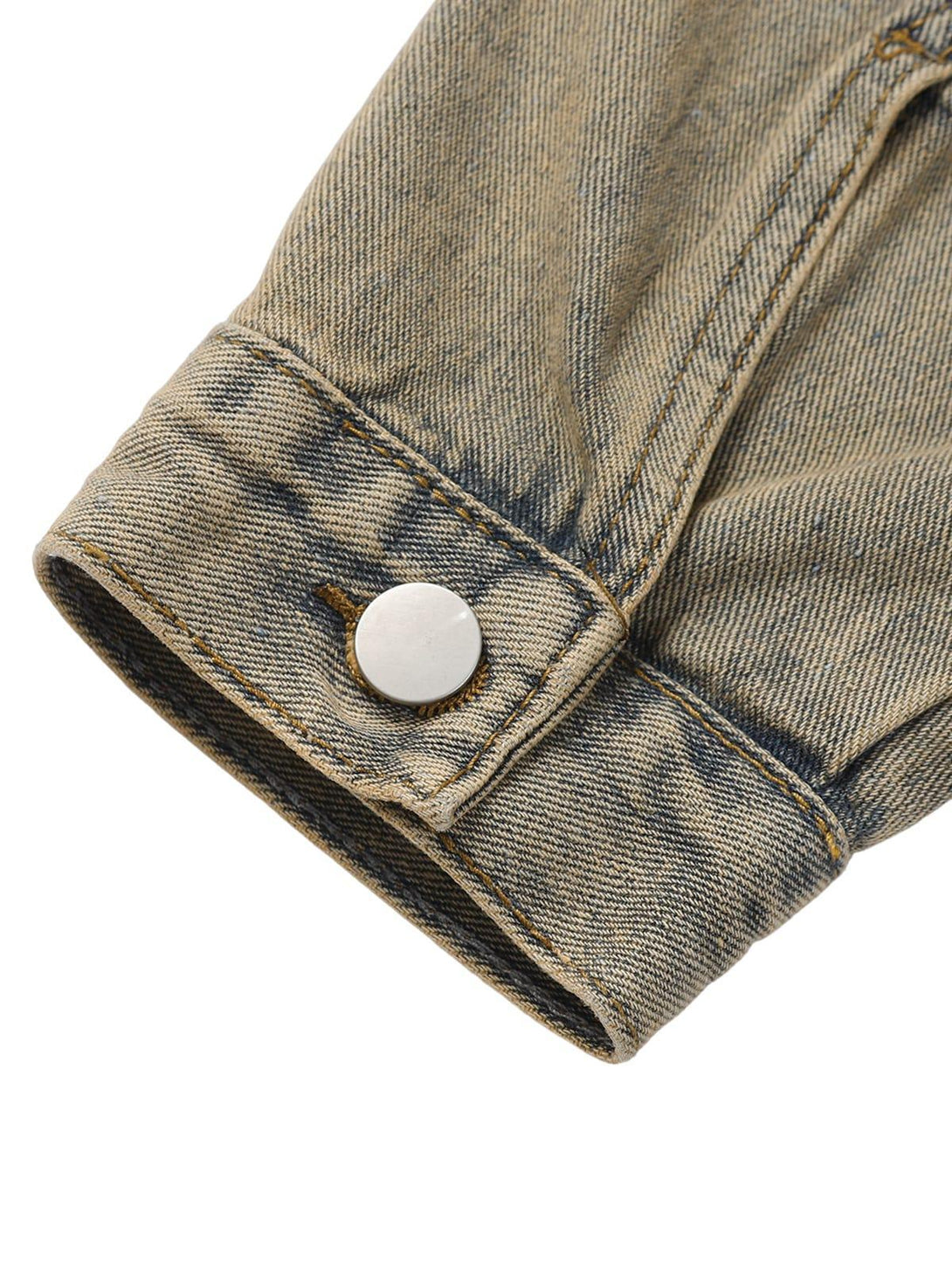 Focusing on the cuff detail of TALISHKO's washed denim jacket, highlighting its vintage style.