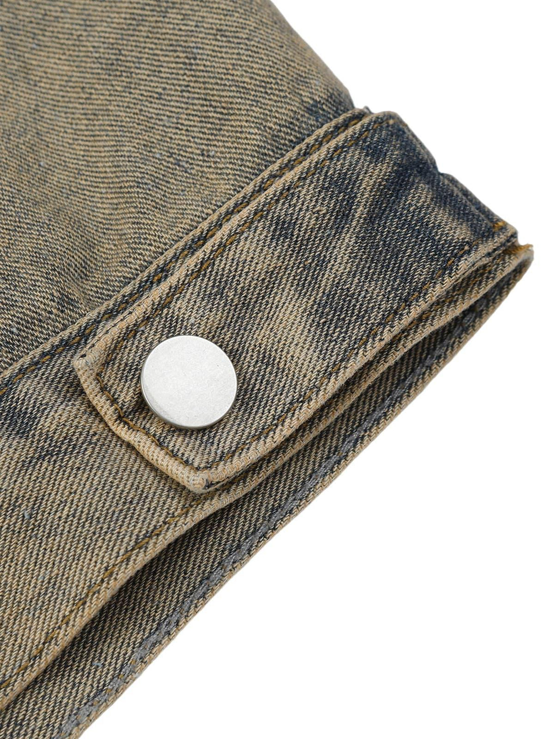 Detailed fabric and stitching on TALISHKO's denim jacket cuff, showcasing vintage style.