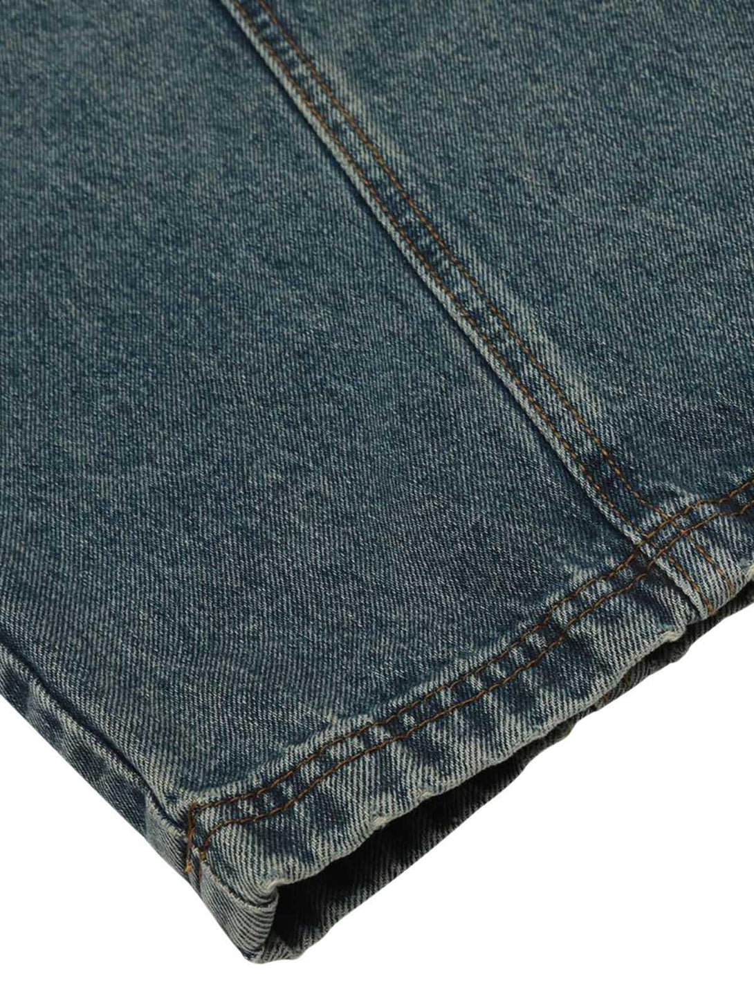 A detailed look at TALISHKO's washed wide-leg balloon jeans, highlighting the intricate stitching.