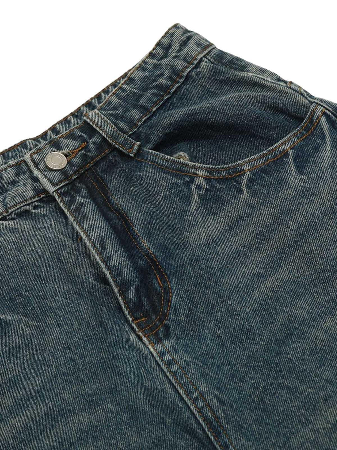 A detailed view of TALISHKO washed wide-leg balloon jeans highlighting the textured denim fabric.