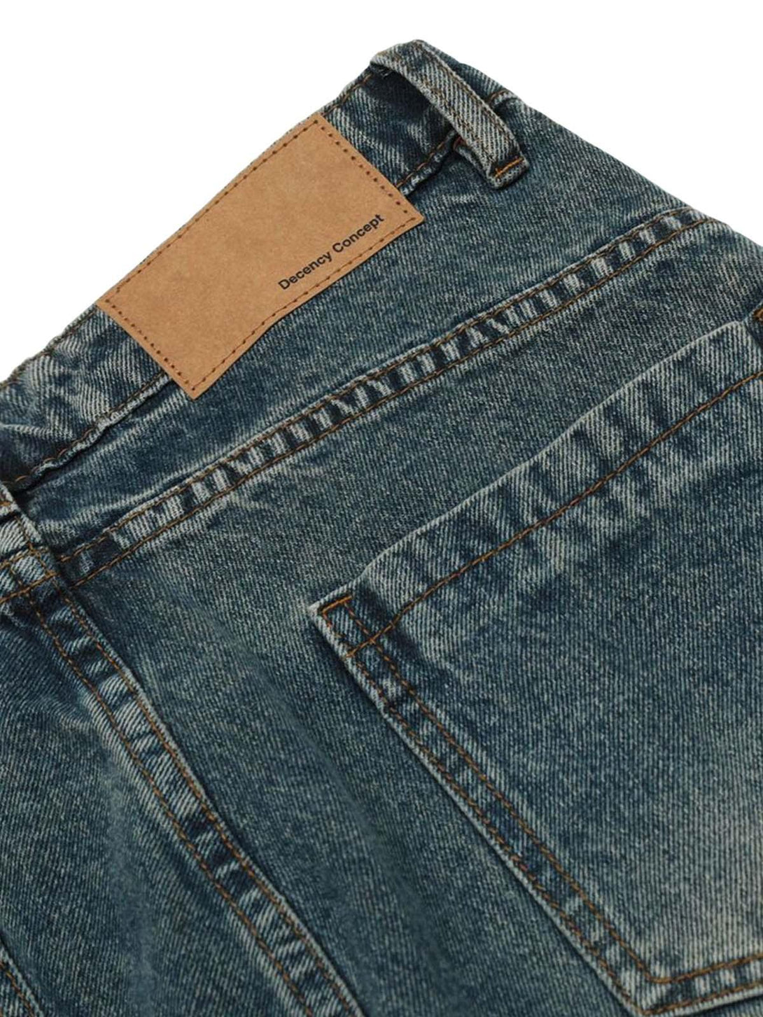 Close-up of TALISHKO washed jeans with detailed back pocket design and textured denim.