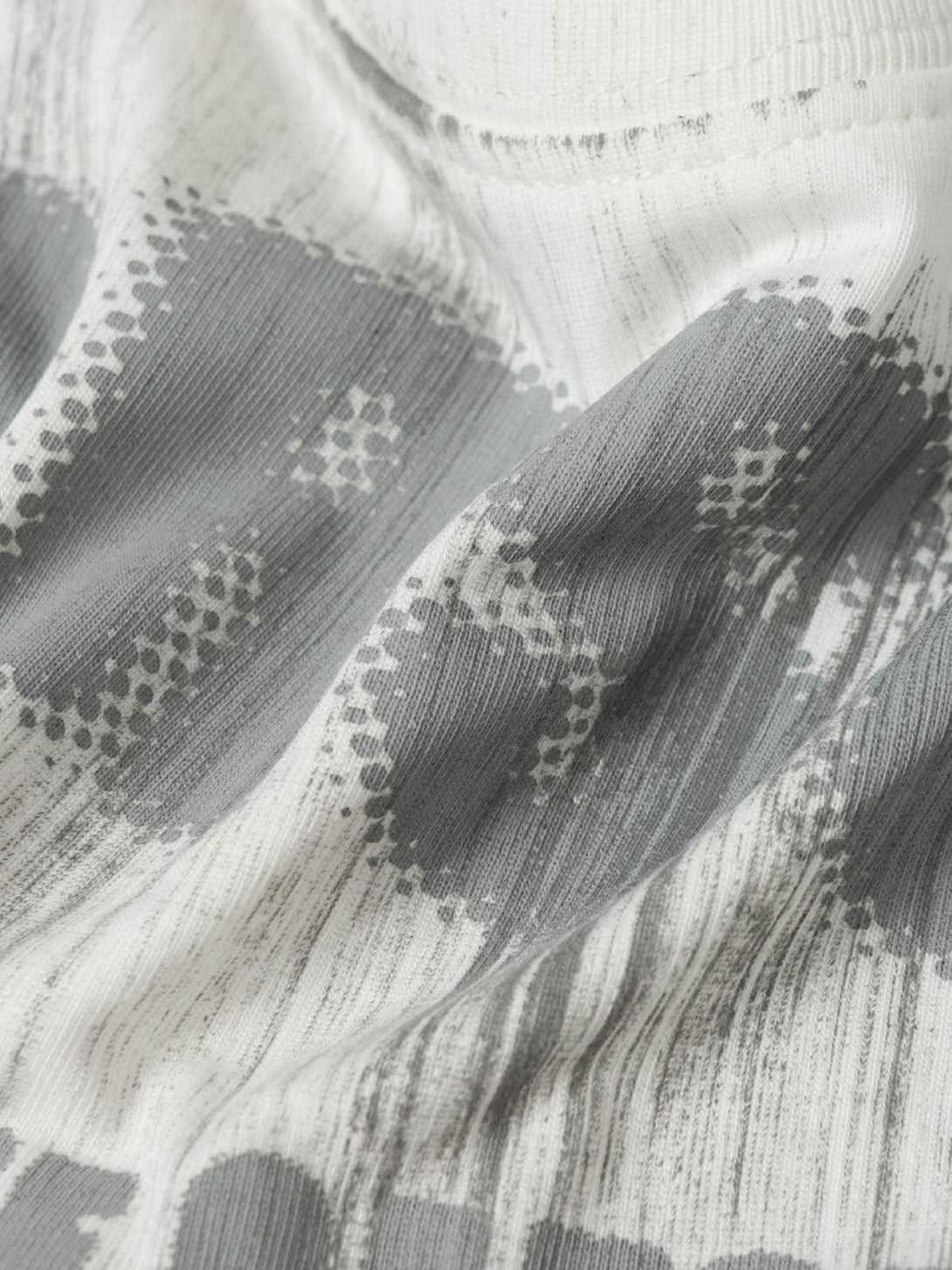 Texture and pattern showcased in TALISHKO's Wasteland Dirty Dye T-shirt, highlighting unique design.