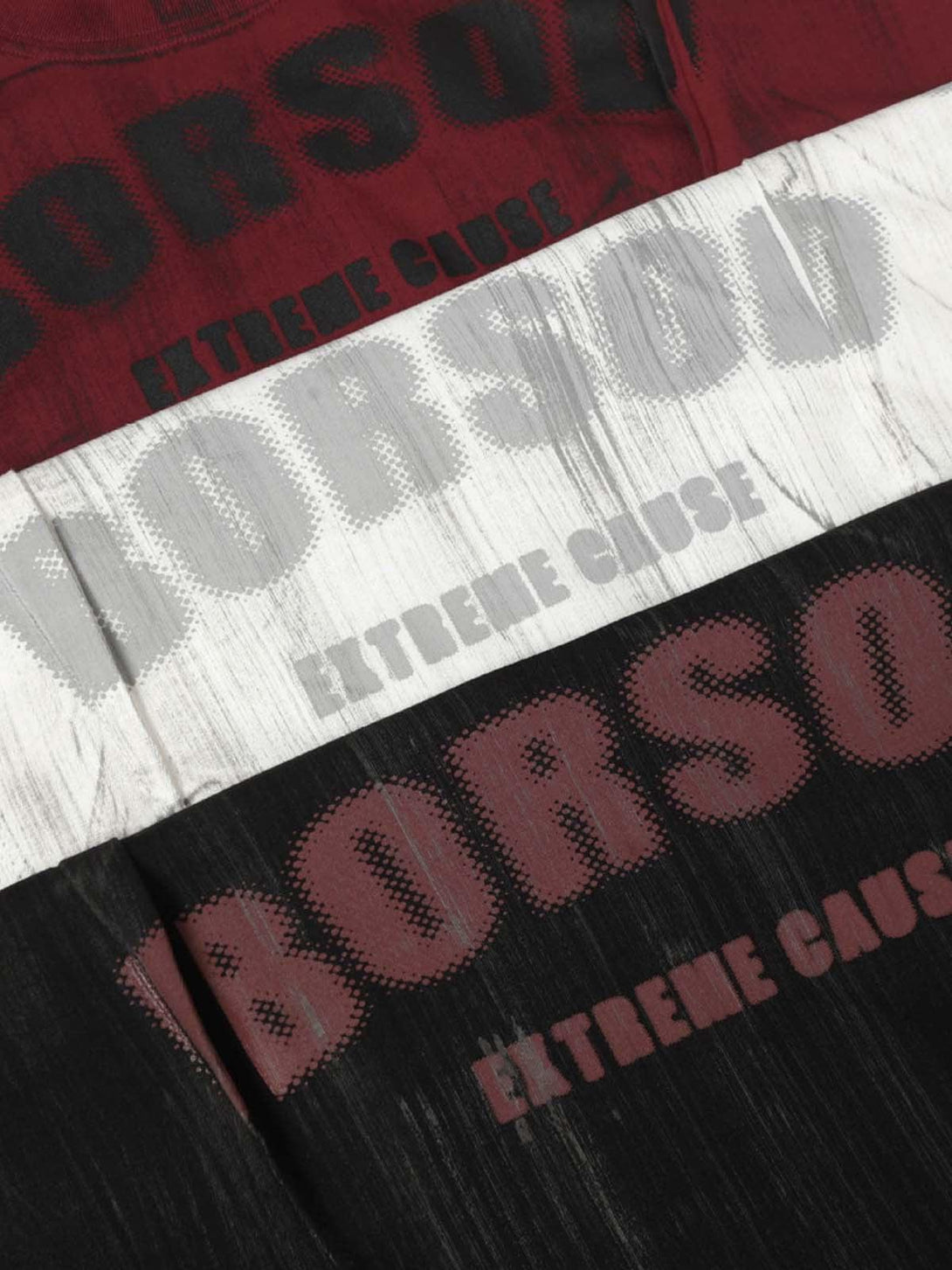 A tight crop highlighting TALISHKO's oversized T-shirt with bold graphic text and unique dye patterns.