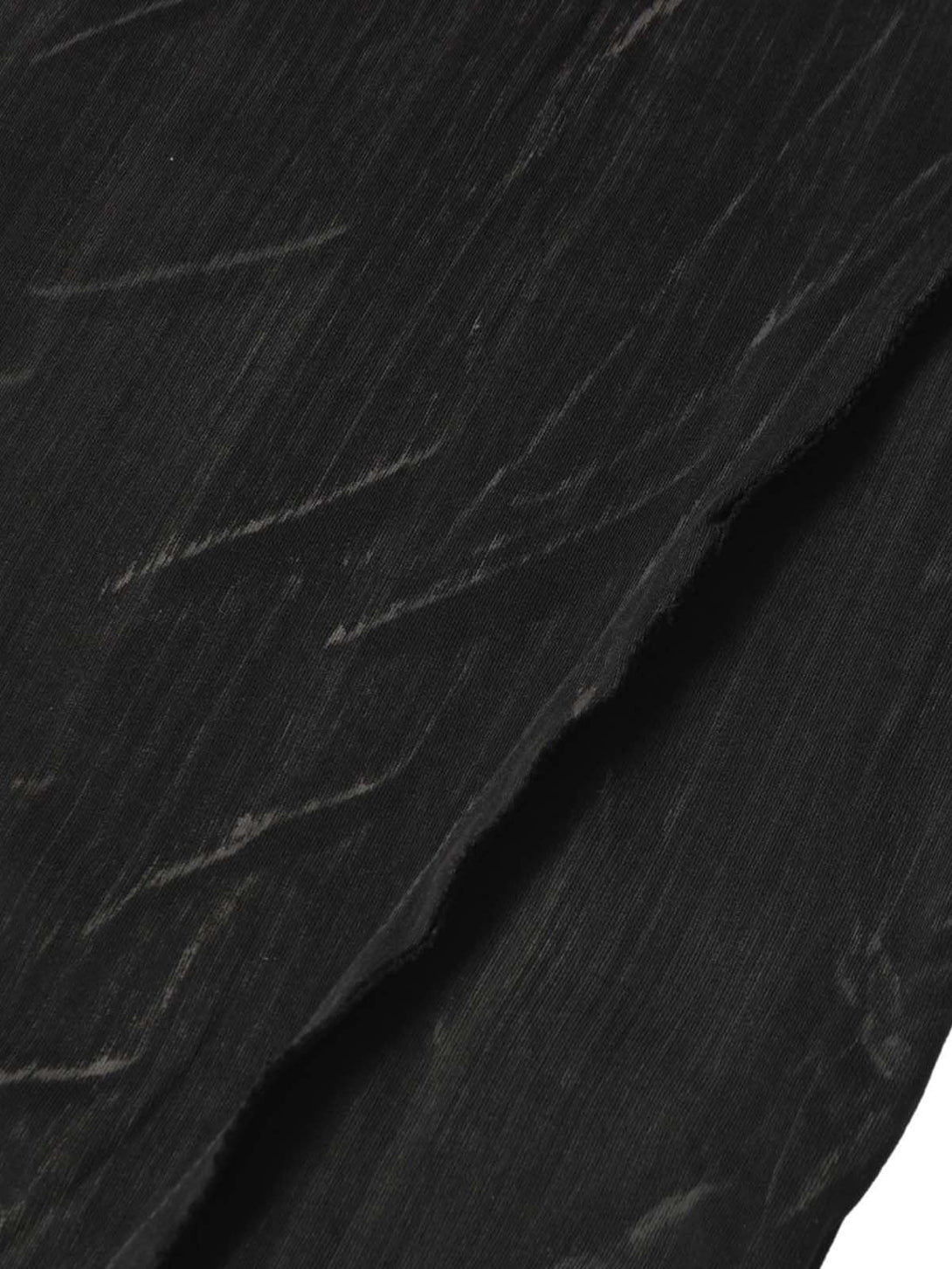 Zoomed-in texture of TALISHKO's Wasteland Dirty Dye T-shirt showcasing unique dye patterns.