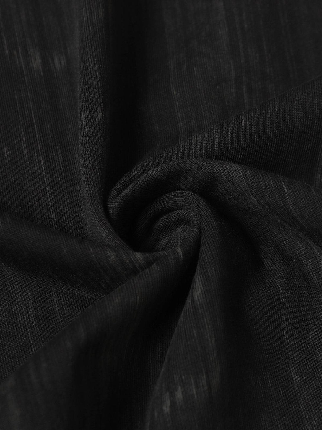 A detailed view of TALISHKO's Wasteland Dirty Dye T-shirt, showcasing its rich black texture.