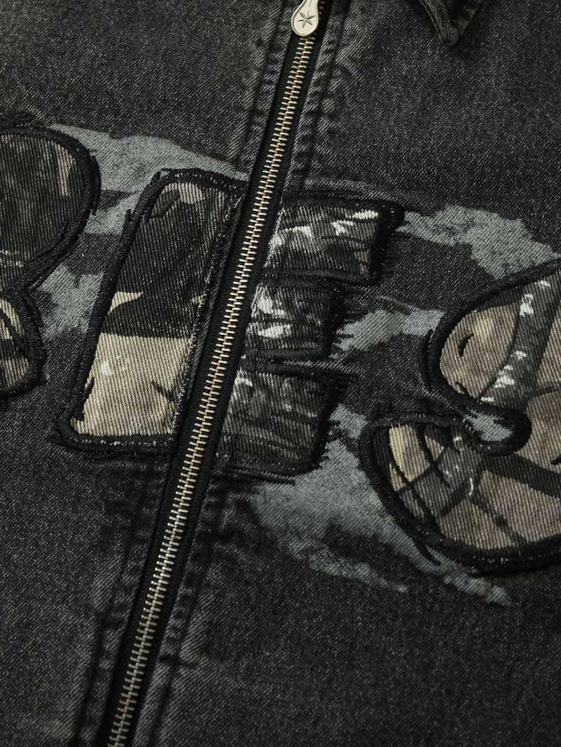 Intricate embroidery on TALISHKO denim jacket, showcasing rugged texture and bold design.