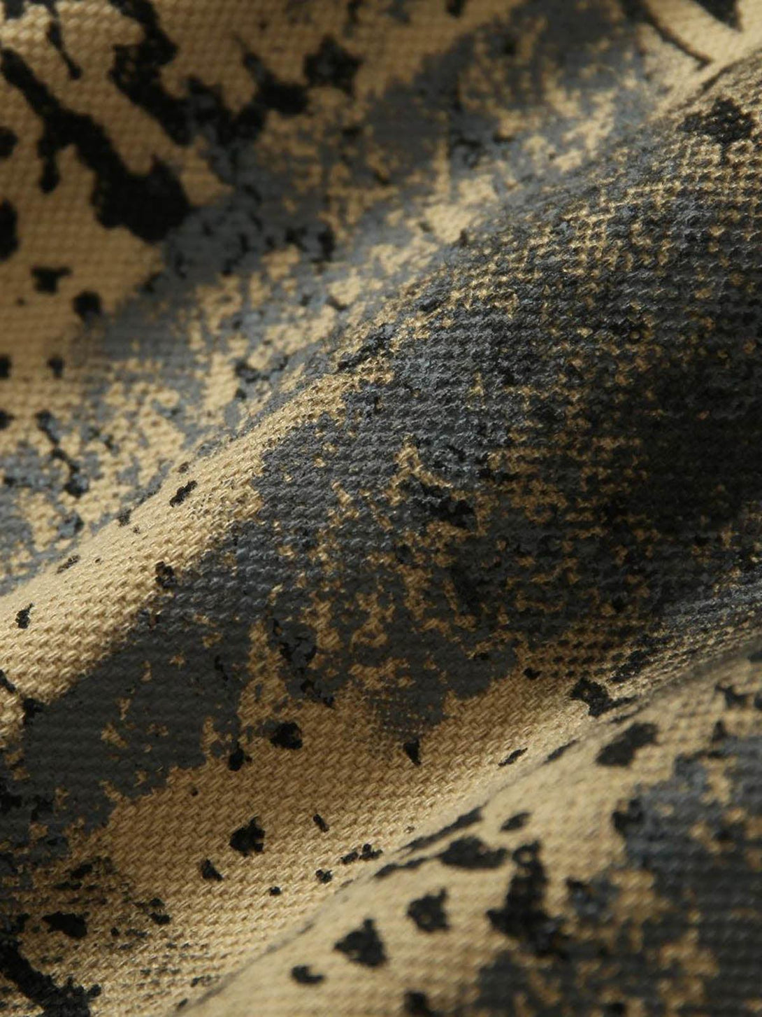 Texture and pattern showcased on TALISHKO's jacket, featuring a graffiti-inspired design.