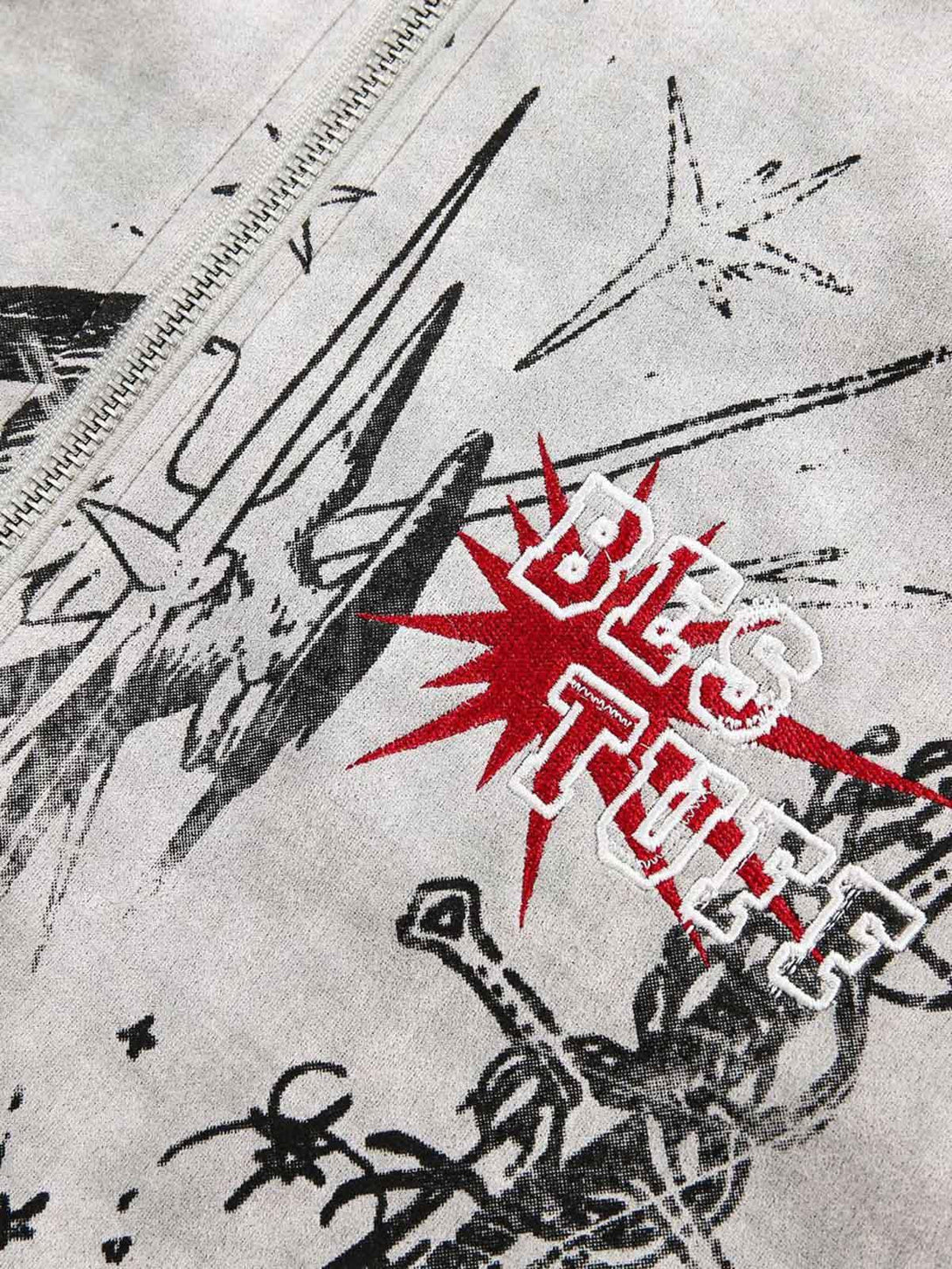 A detailed view of TALISHKO's graffiti-inspired zip-up jacket with bold red and black designs.
