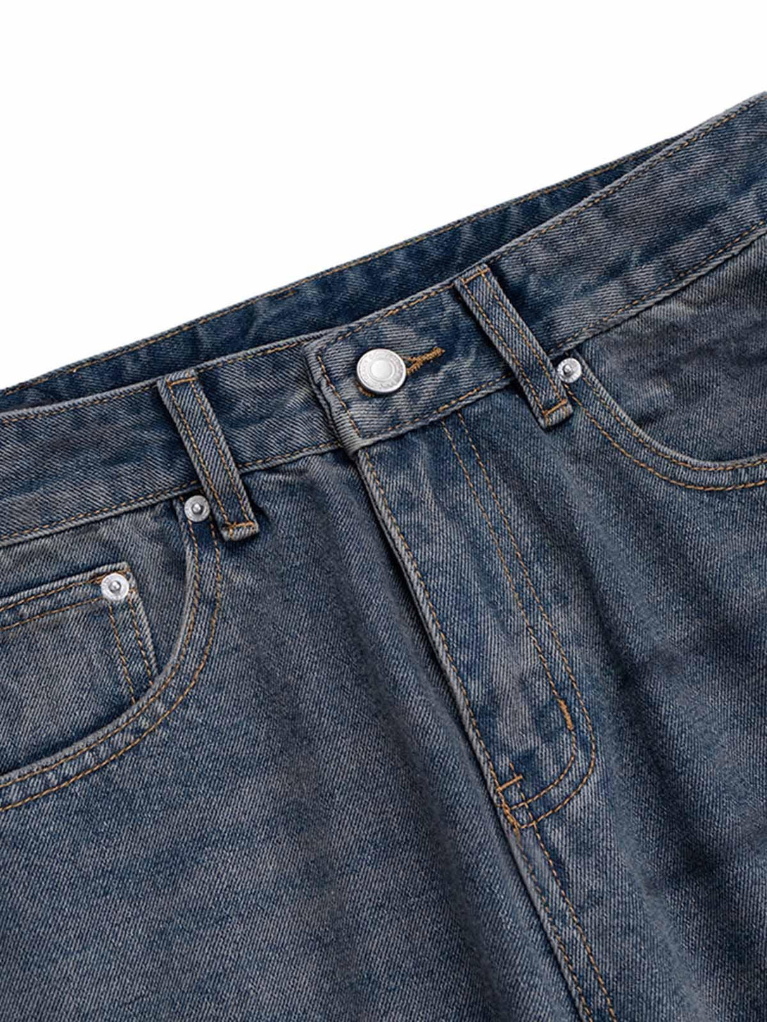 Close-up of TALISHKO's baggy jeans waistband, highlighting denim texture and stitching detail.