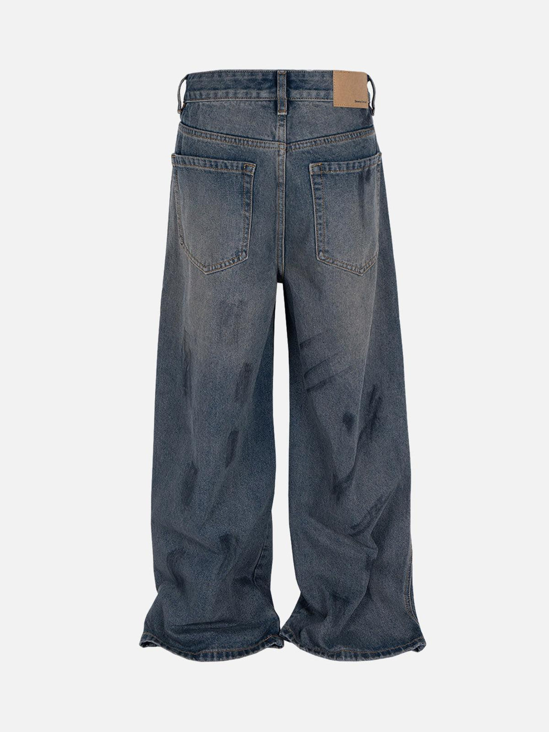 Back view of TALISHKO's baggy jeans with ink splash, showcasing urban streetwear vibes.