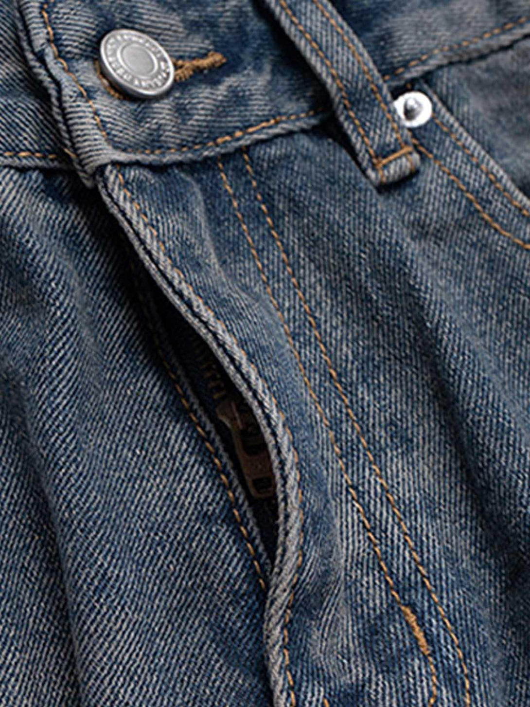 A tight crop highlighting the ink splash design and stitching on TALISHKO's baggy jeans.