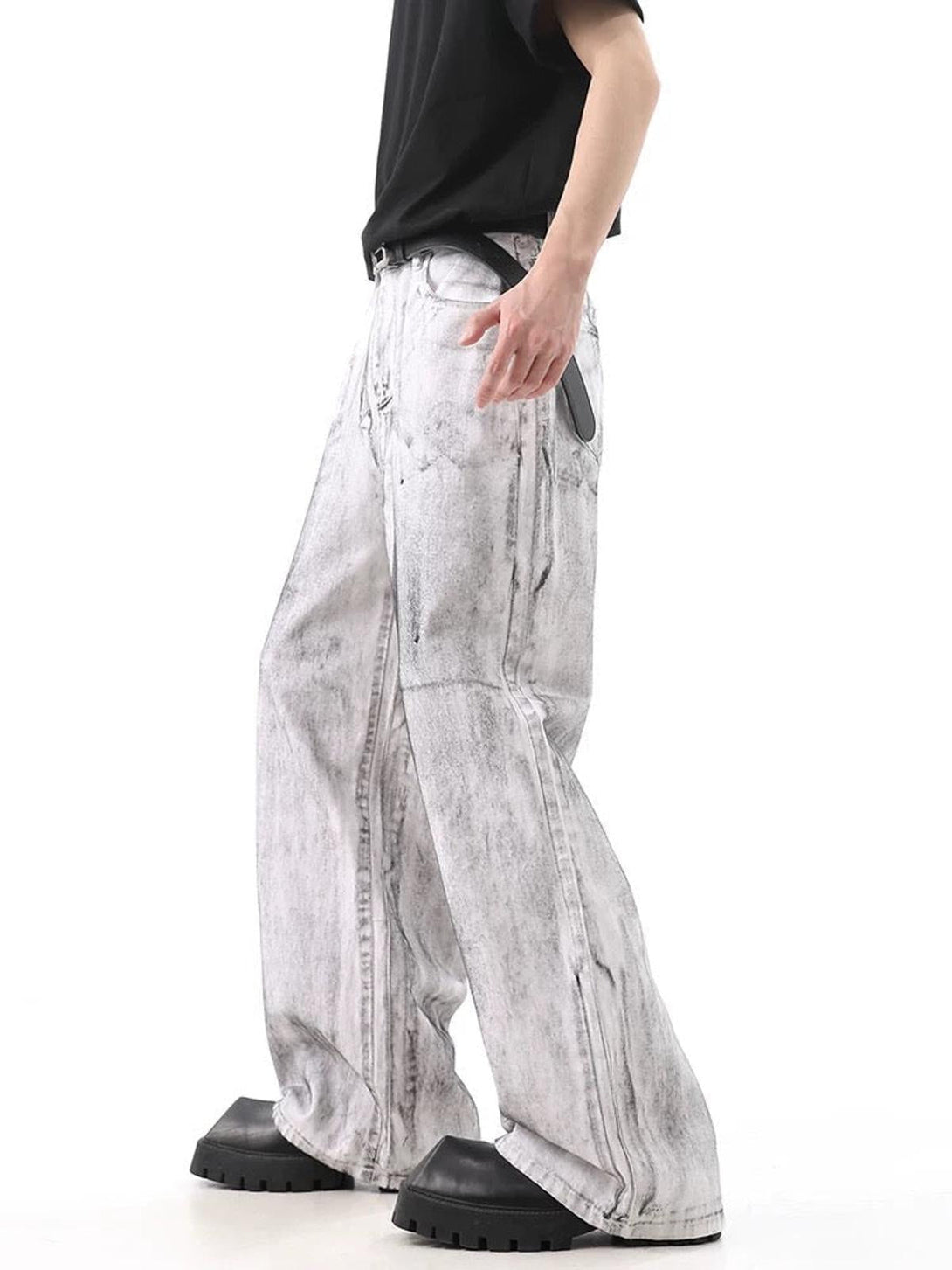 Side view of TALISHKO's loose-fit jeans in distressed white, showcasing their niche wasteland style.