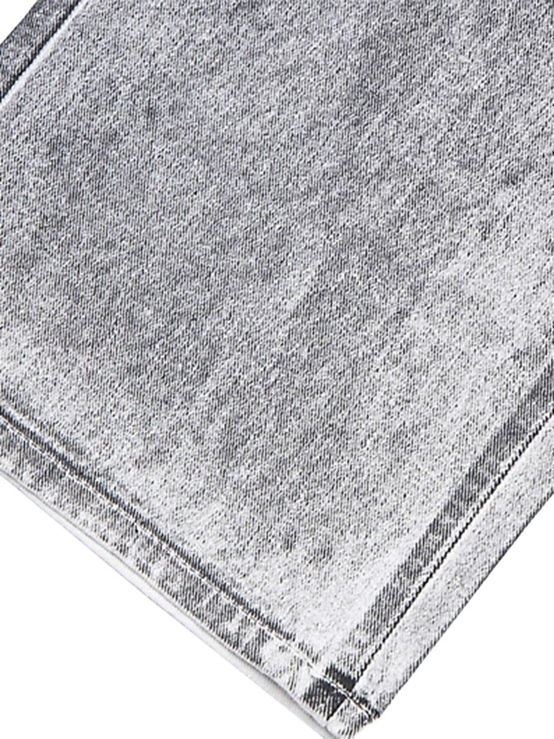 Zoomed-in texture of TALISHKO's distressed white jeans, highlighting niche design details.