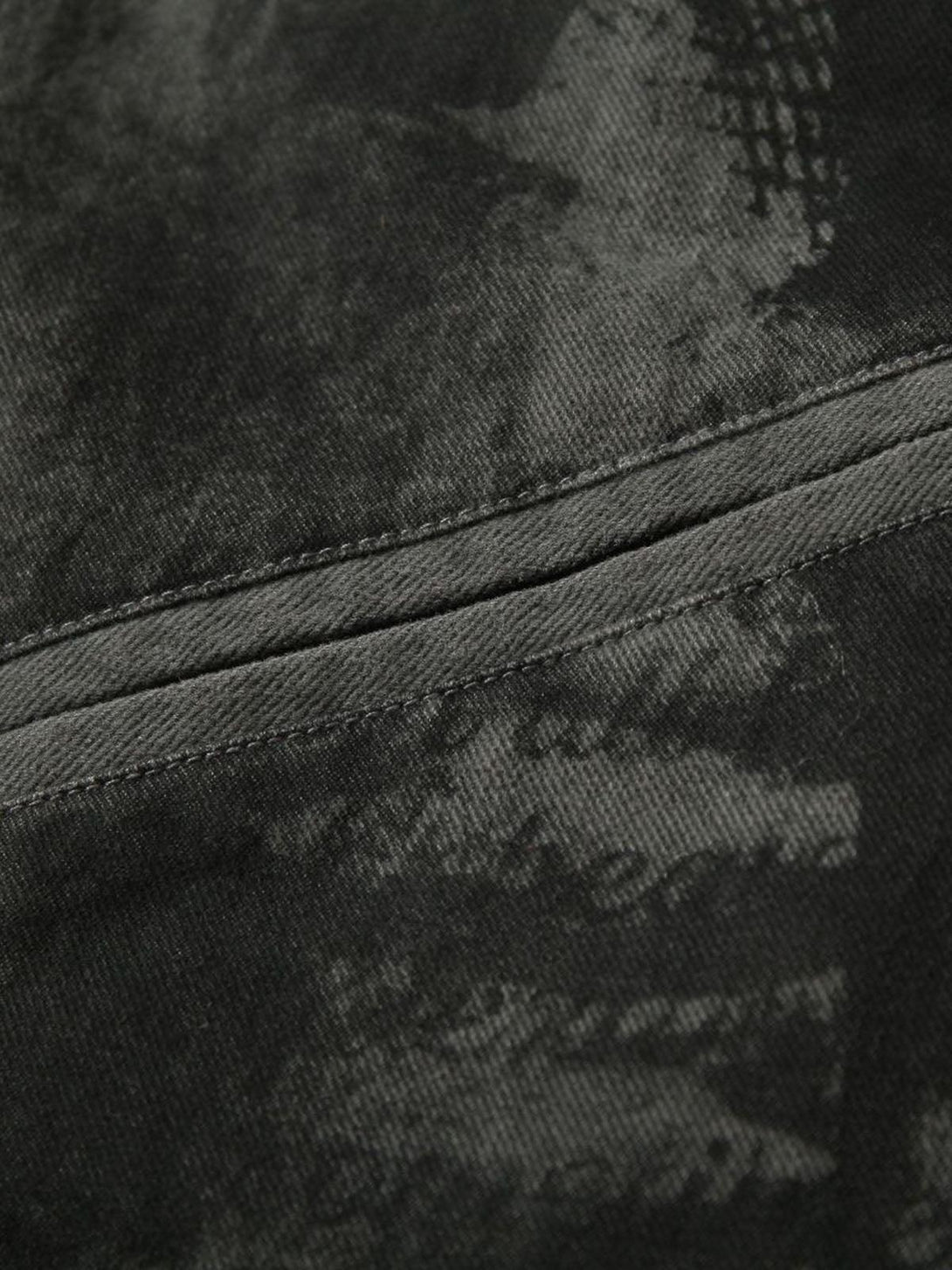 Detailed fabric and stitching of TALISHKO's barn jacket, showcasing unique textures and patterns.
