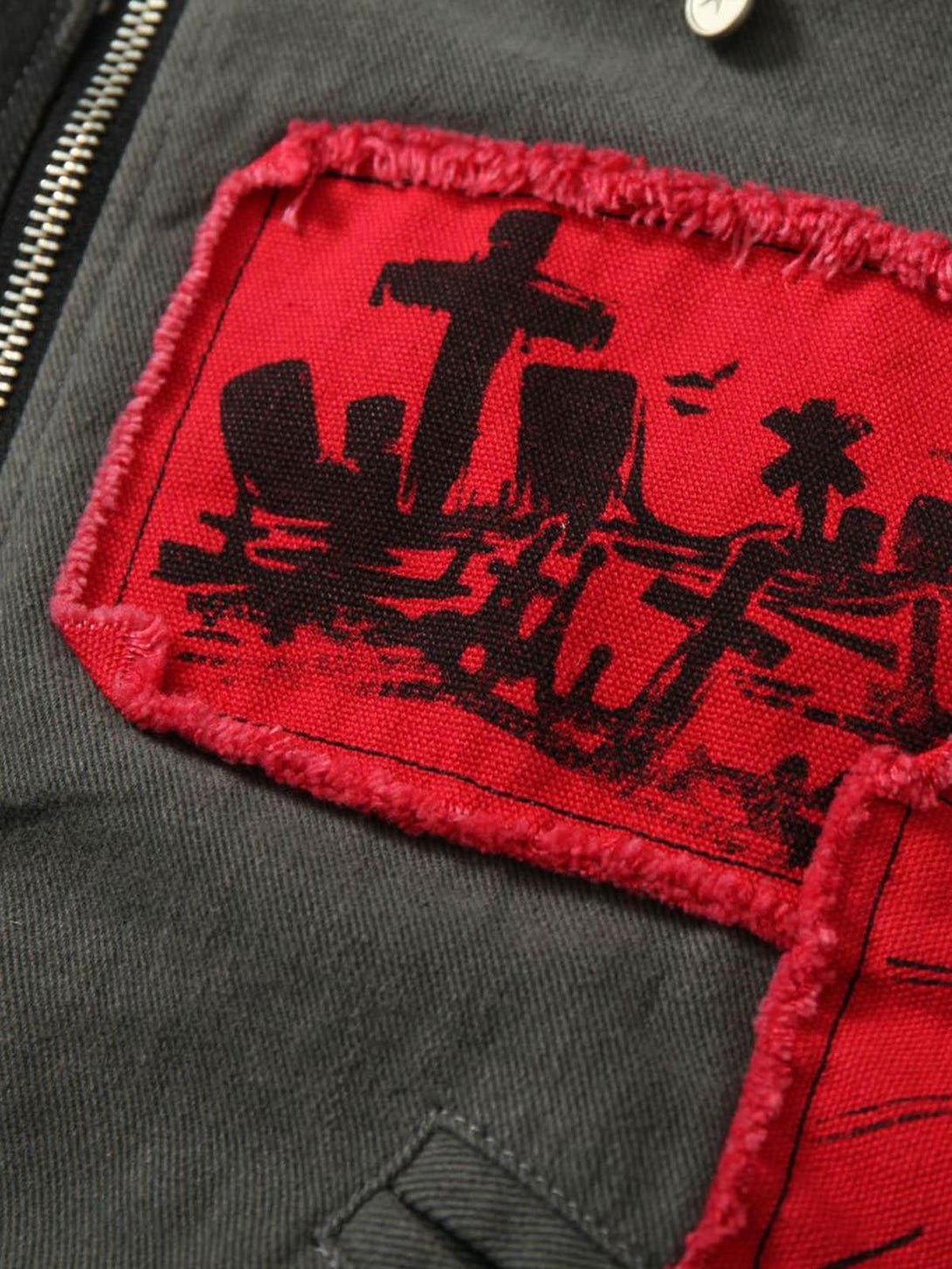 Intricate view of TALISHKO barn jacket, showcasing red patch with bold black cemetery print.