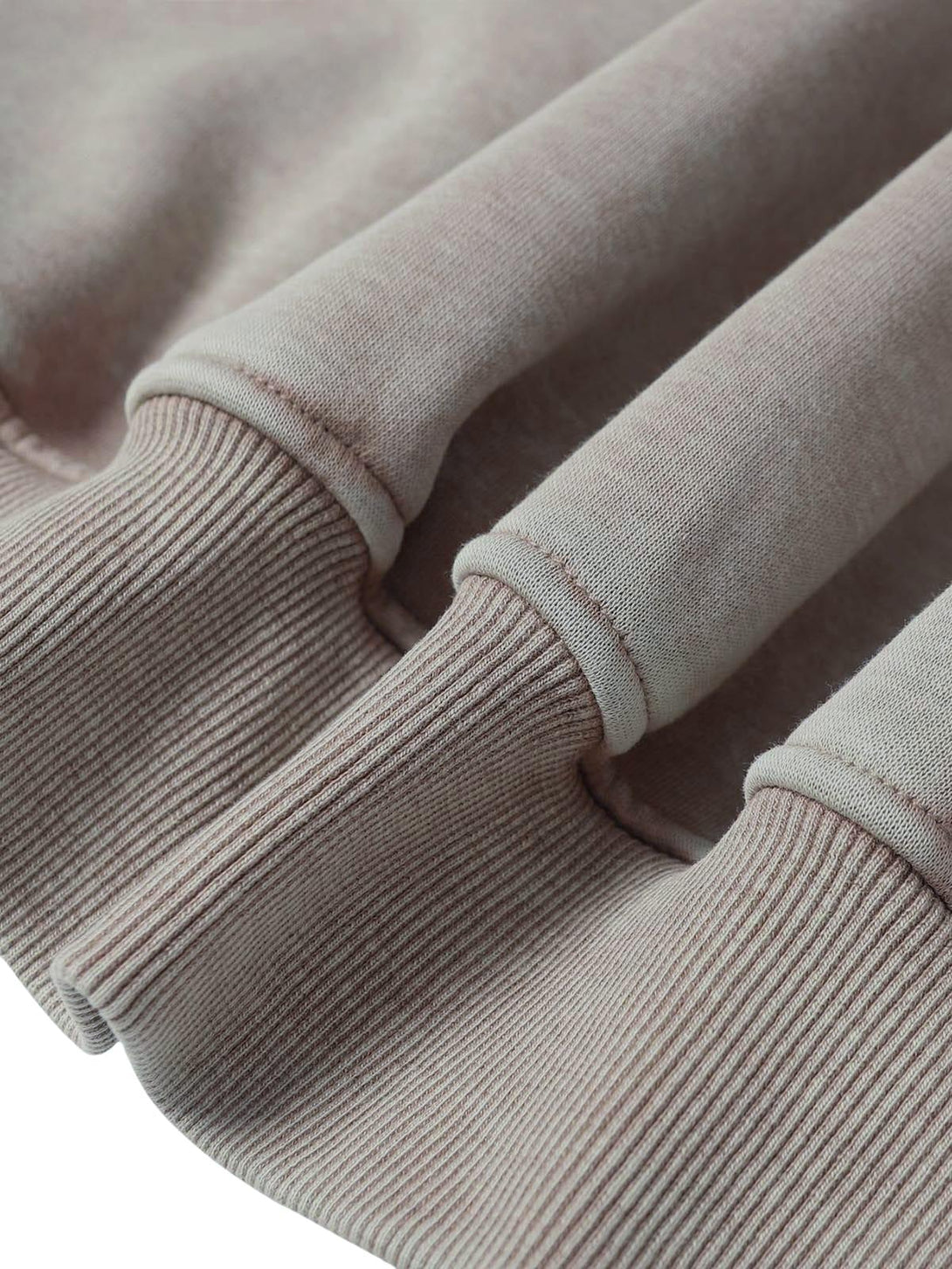 "Zoomed-in texture of TALISHKO's washed zipper-up sweatshirt, highlighting ribbed details."
