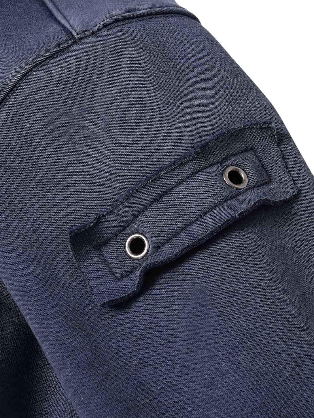 "Detailed fabric and stitching on TALISHKO's washed zipper-up sweatshirt, highlighting grommet accents."