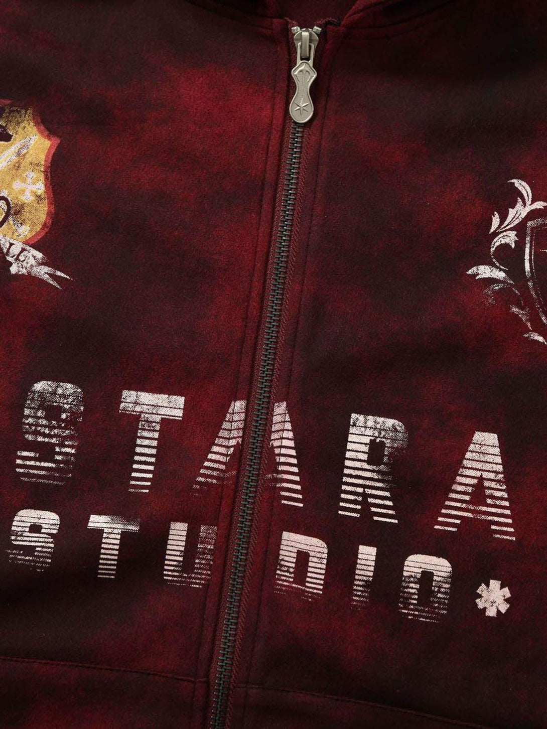 A close-up of TALISHKO's red tie-dye zipper jacket, highlighting bold text and graphic details.