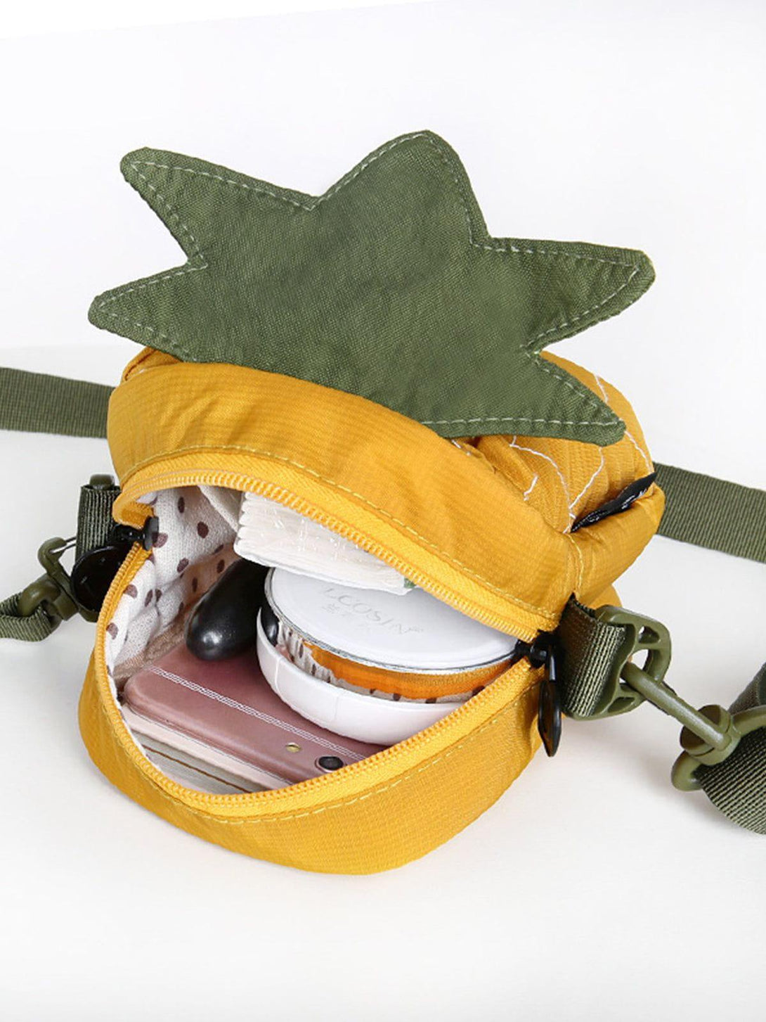 A cute pineapple-shaped bag by TALISHKO, showcasing a playful design with a polka dot interior.