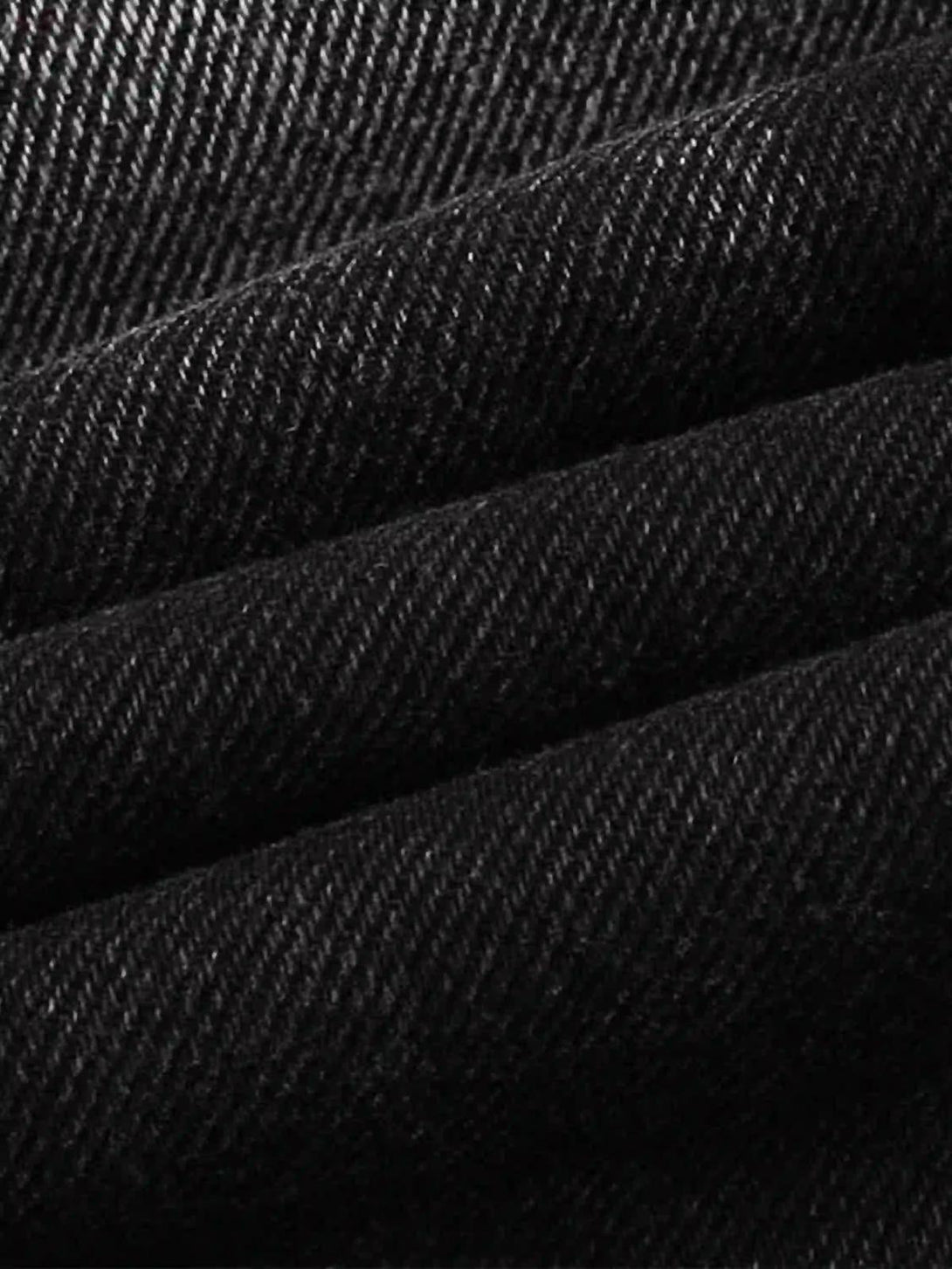 Zoomed-in texture of TALISHKO cargo jeans, showcasing intricate fabric and water ripple design.
