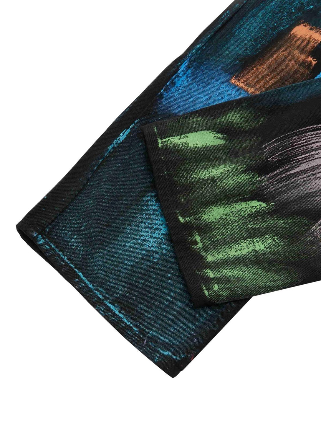 A detailed view of TALISHKO watercolor print jeans, highlighting vibrant artistic textures.