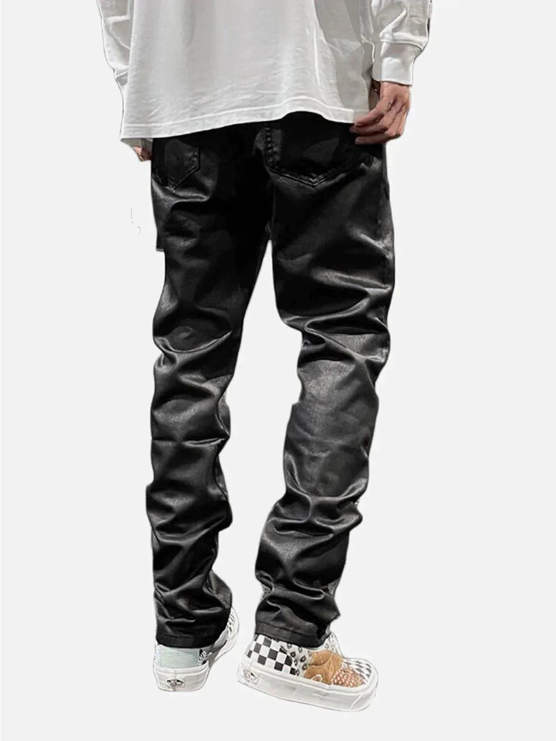 Back view of black waxed slim pants by TALISHKO, styled casually with white sneakers.