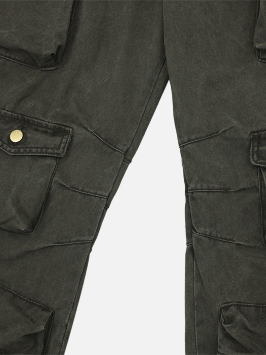 A detailed look at TALISHKO's baggy denim overalls, highlighting the textured pocket design.