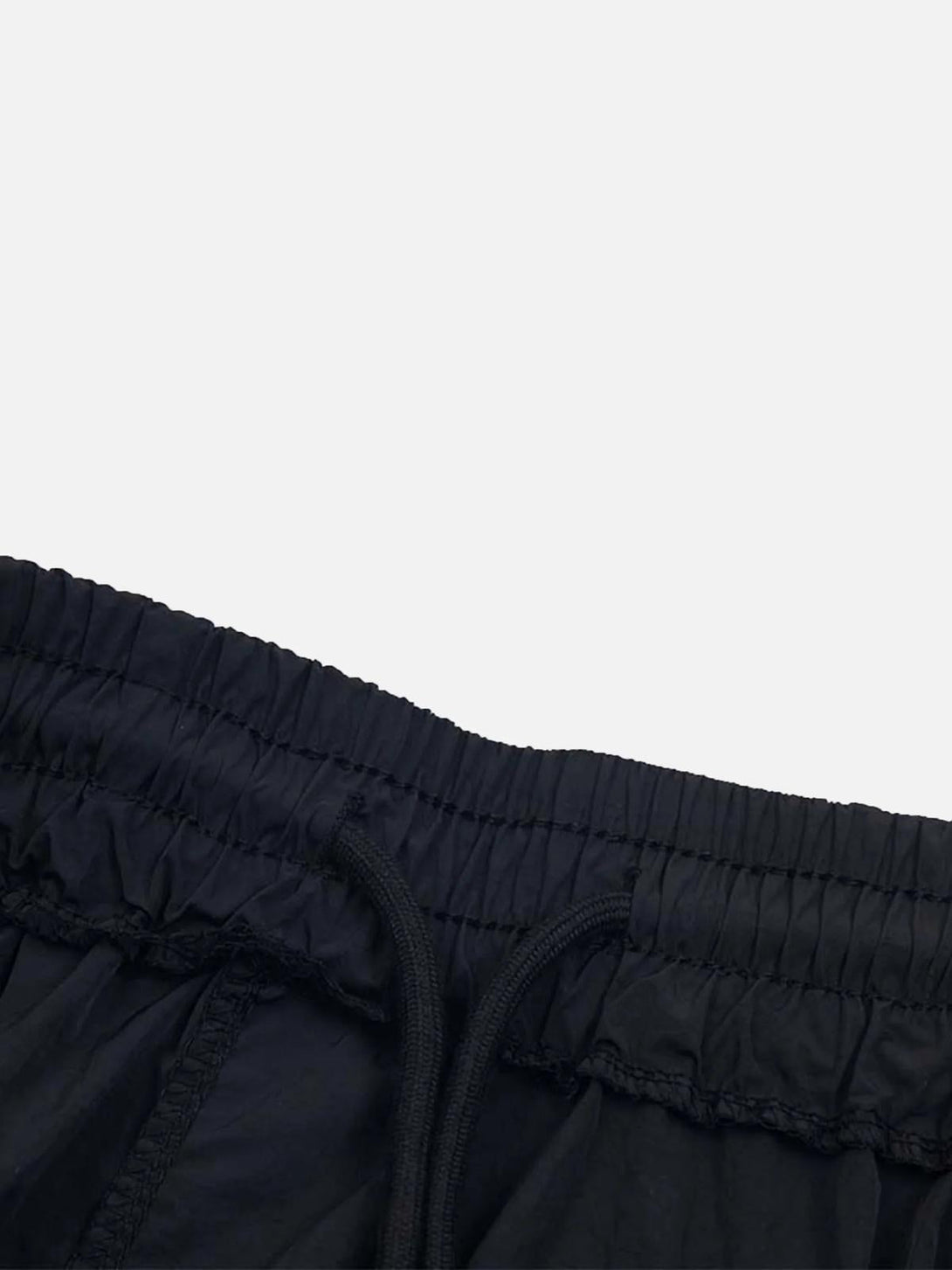 A close-up of TALISHKO sweatpants' elastic waistband and drawstring detail in black.