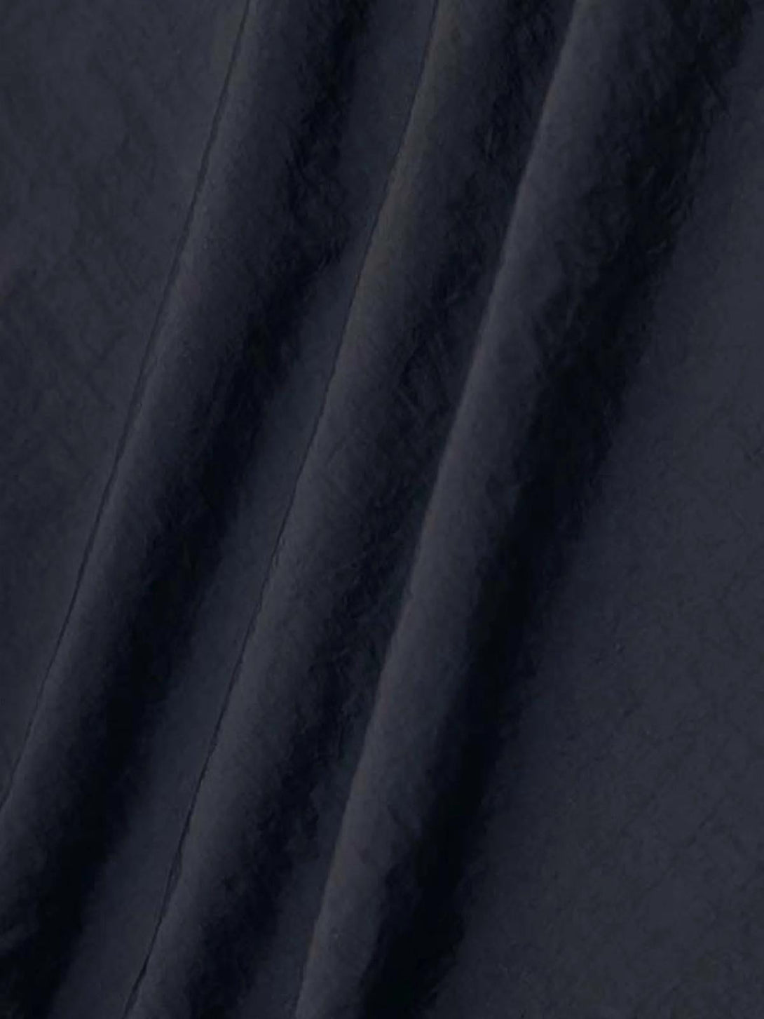 A detailed view of TALISHKO sweatpants fabric, showcasing deep, rich texture and quality.