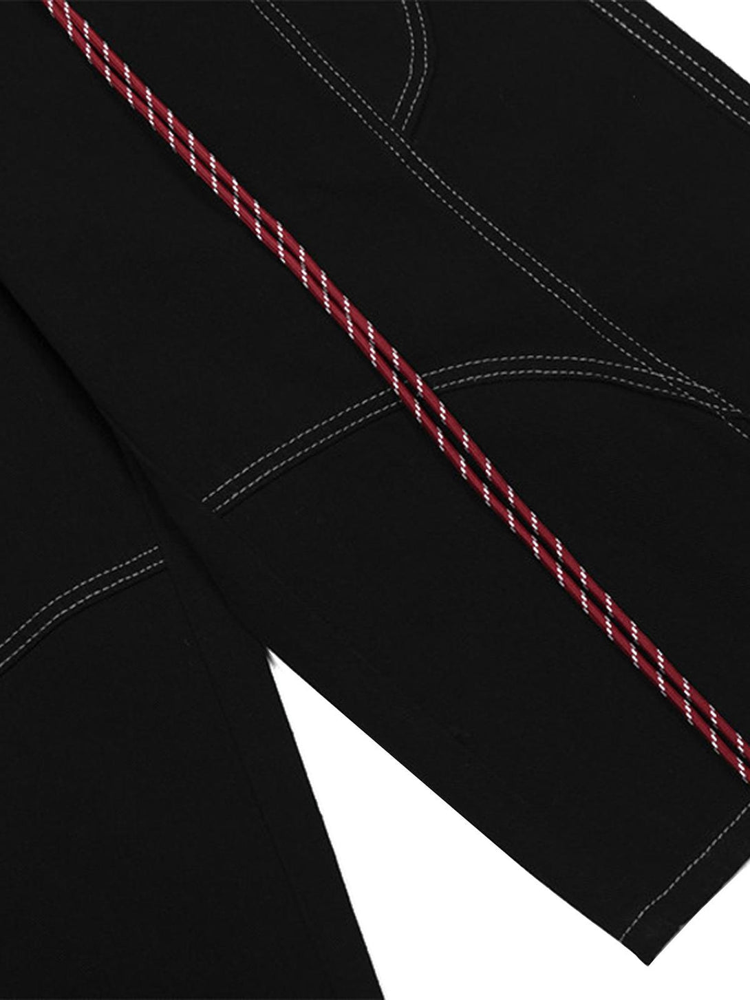 Detailed fabric and stitching view of TALISHKO cargo jorts, featuring red welt embellishment.