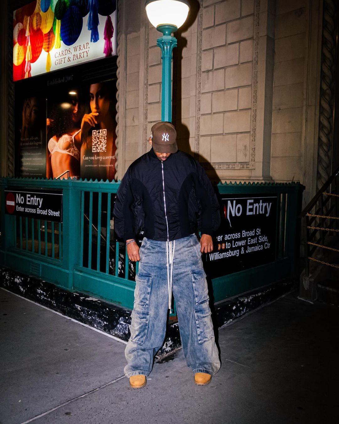 Model showcasing TALISHKO loose, wide-leg jeans with multiple pockets, paired with a dark jacket.