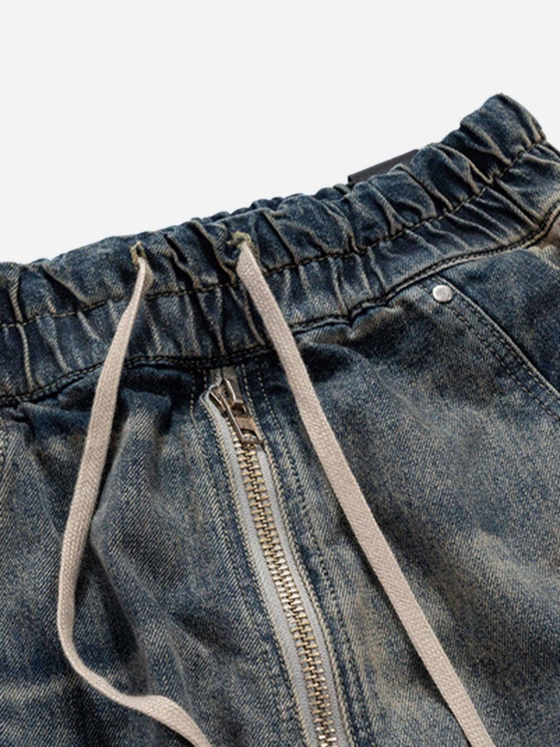 Focusing on the elastic waistband and drawstring detail of TALISHKO loose jeans.