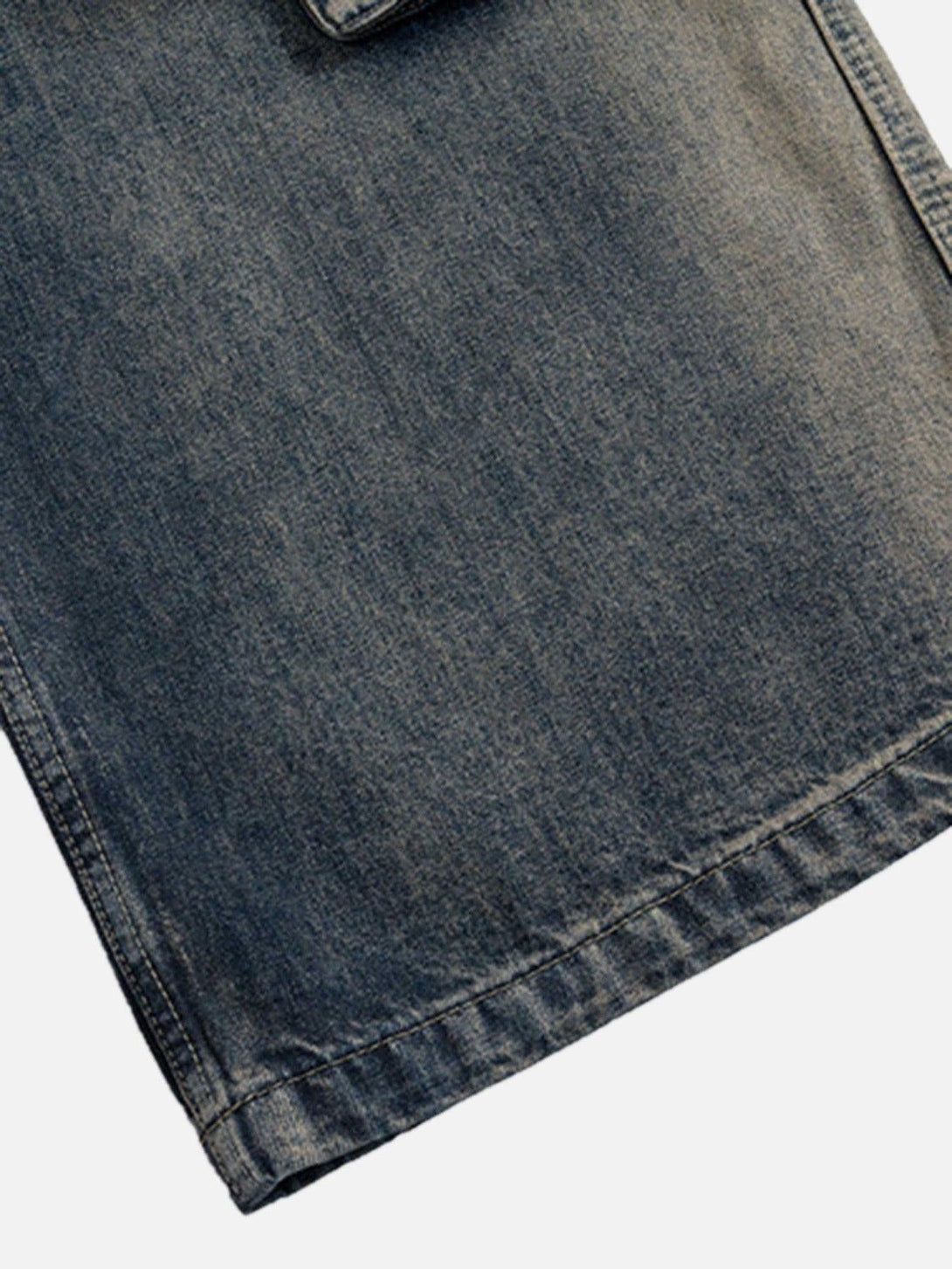 Detailed view of TALISHKO wide-leg jeans showcasing the texture and stitching.